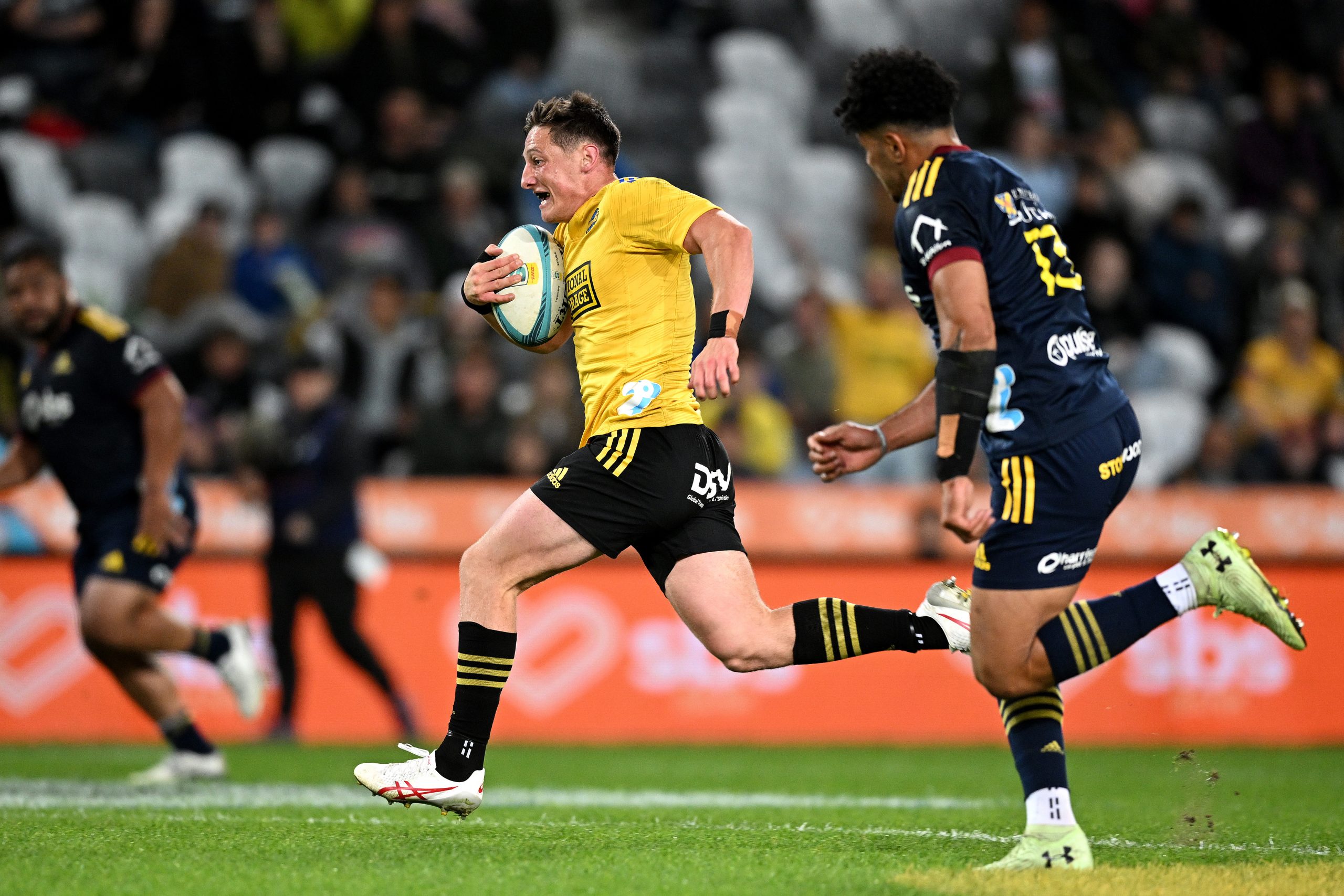 Cameron Roigard of the Hurricanes runs away to score a try.