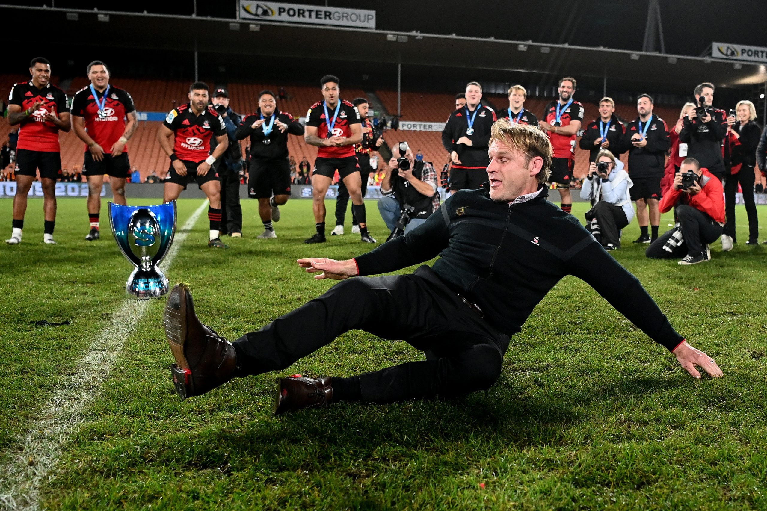 Coach Scott Robertson of the Crusaders breakdances after winning.