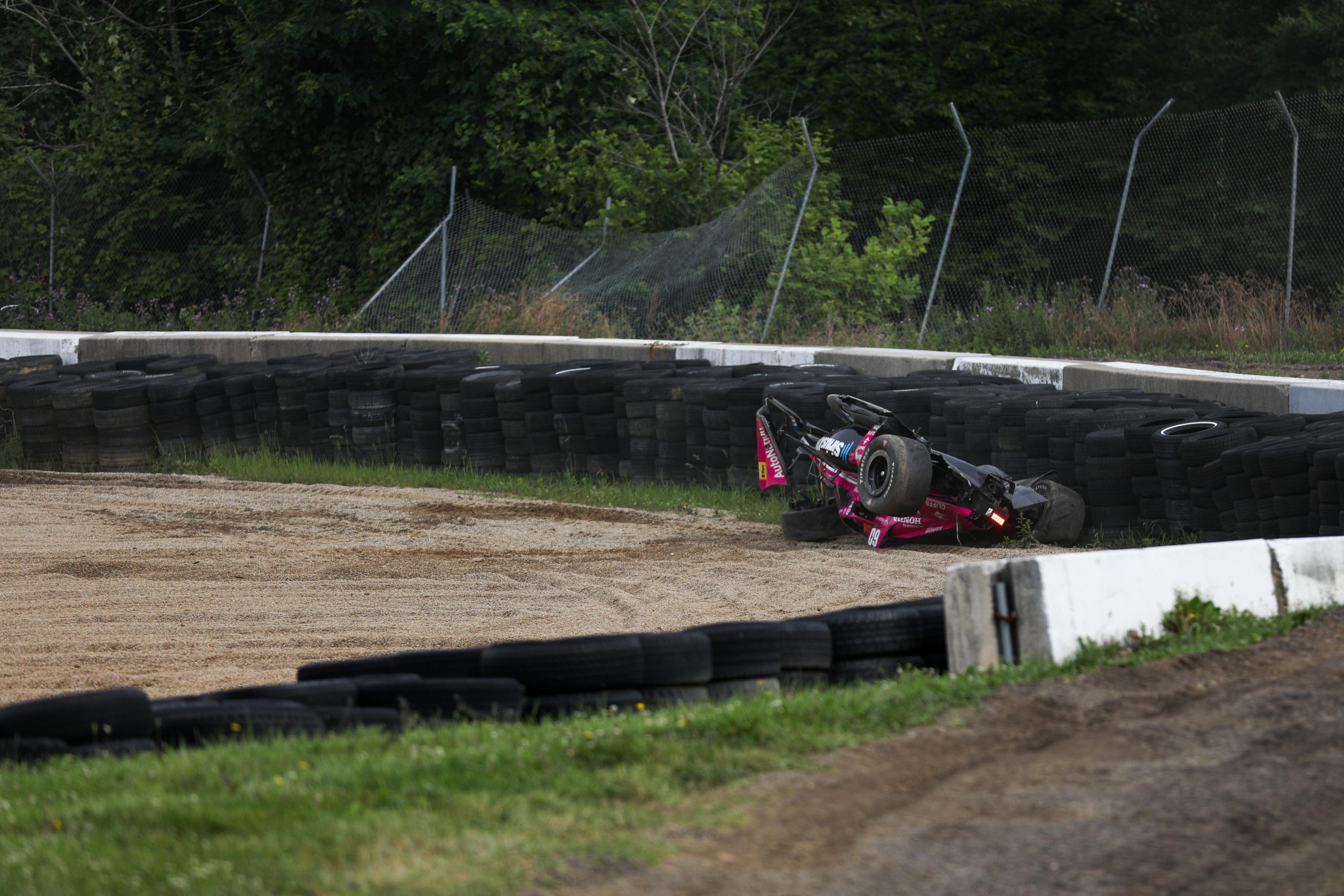 Simon Pagenaud's car lays upsidedown after crashing heavily at Mid-Ohio.