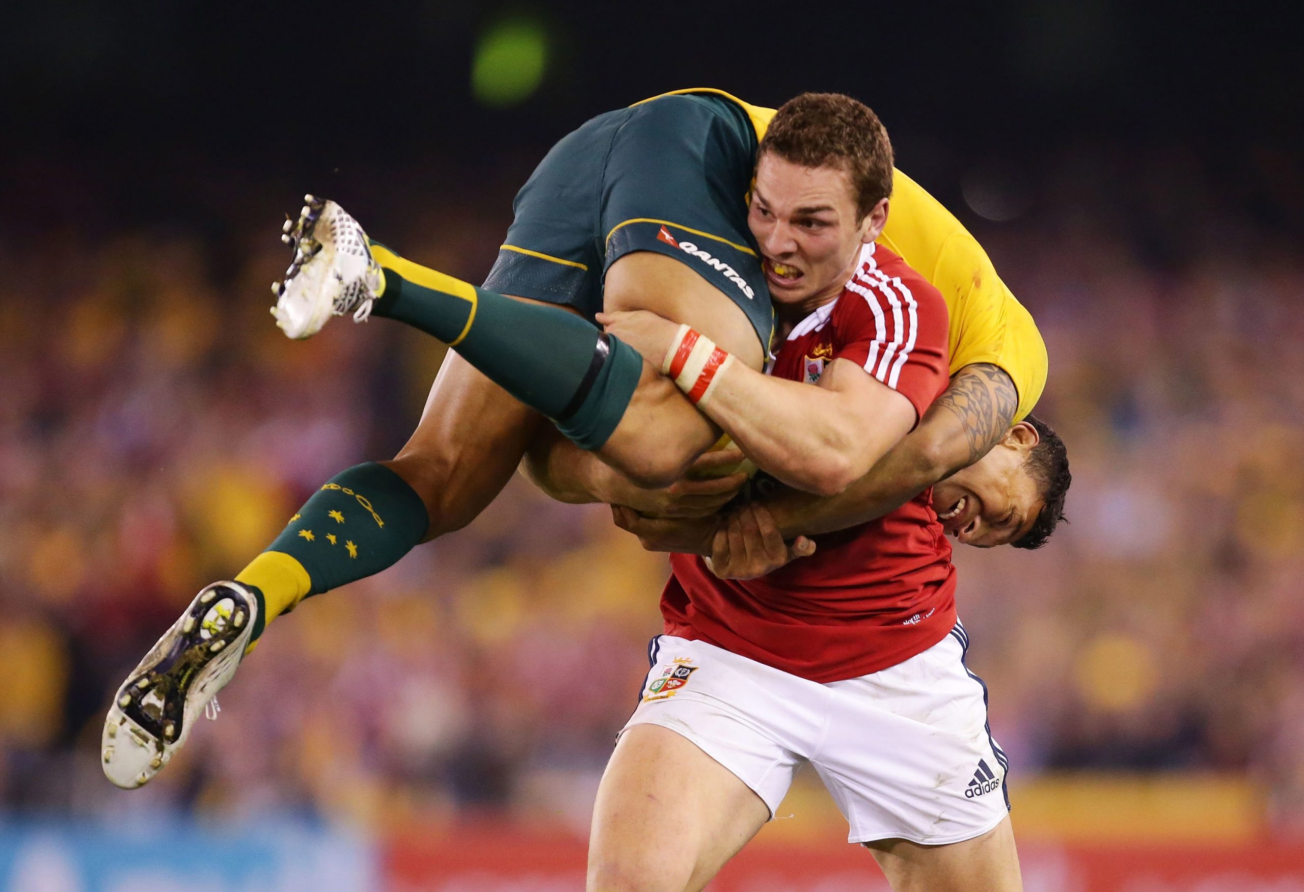 George North of the Lions carries Israel Folau of the Wallabies.