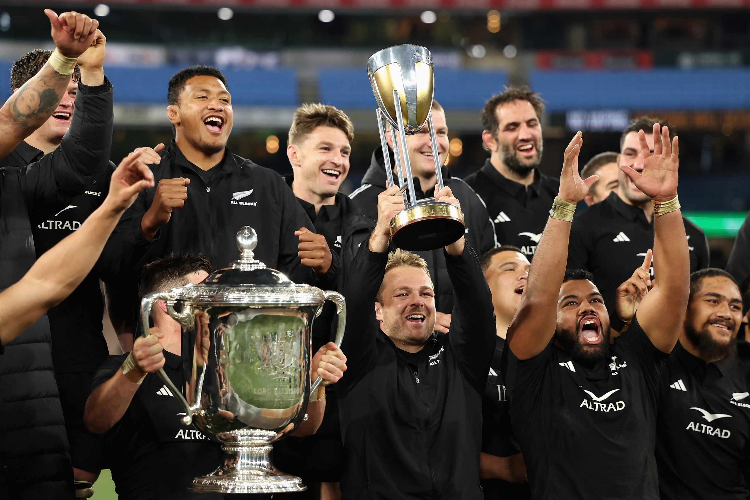 Injured All Blacks captain Sam Cane celebrates with teammates after winning The Rugby Championship and Bledisloe Cup.