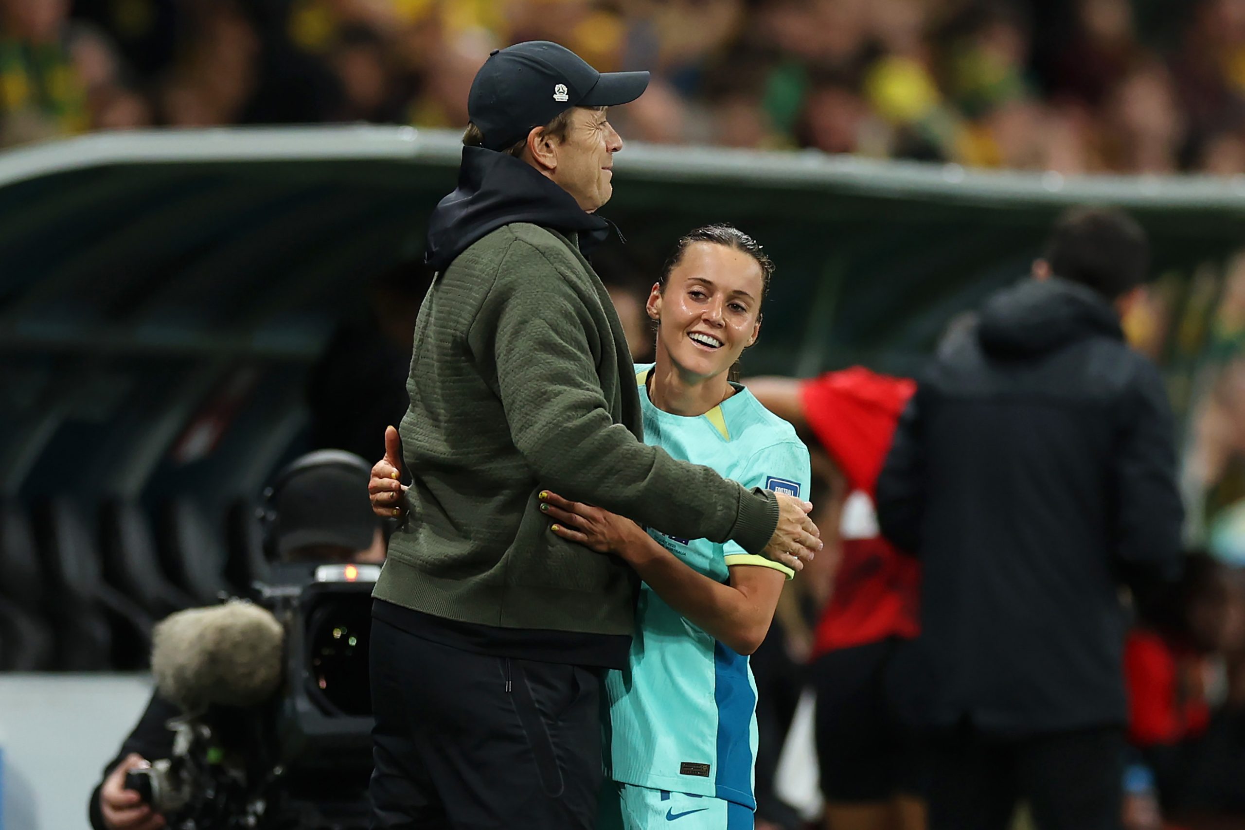 Hayley Raso is embraced by head coach Tony Gustavsson after being substituted in the second half of Australia's match against Canada.