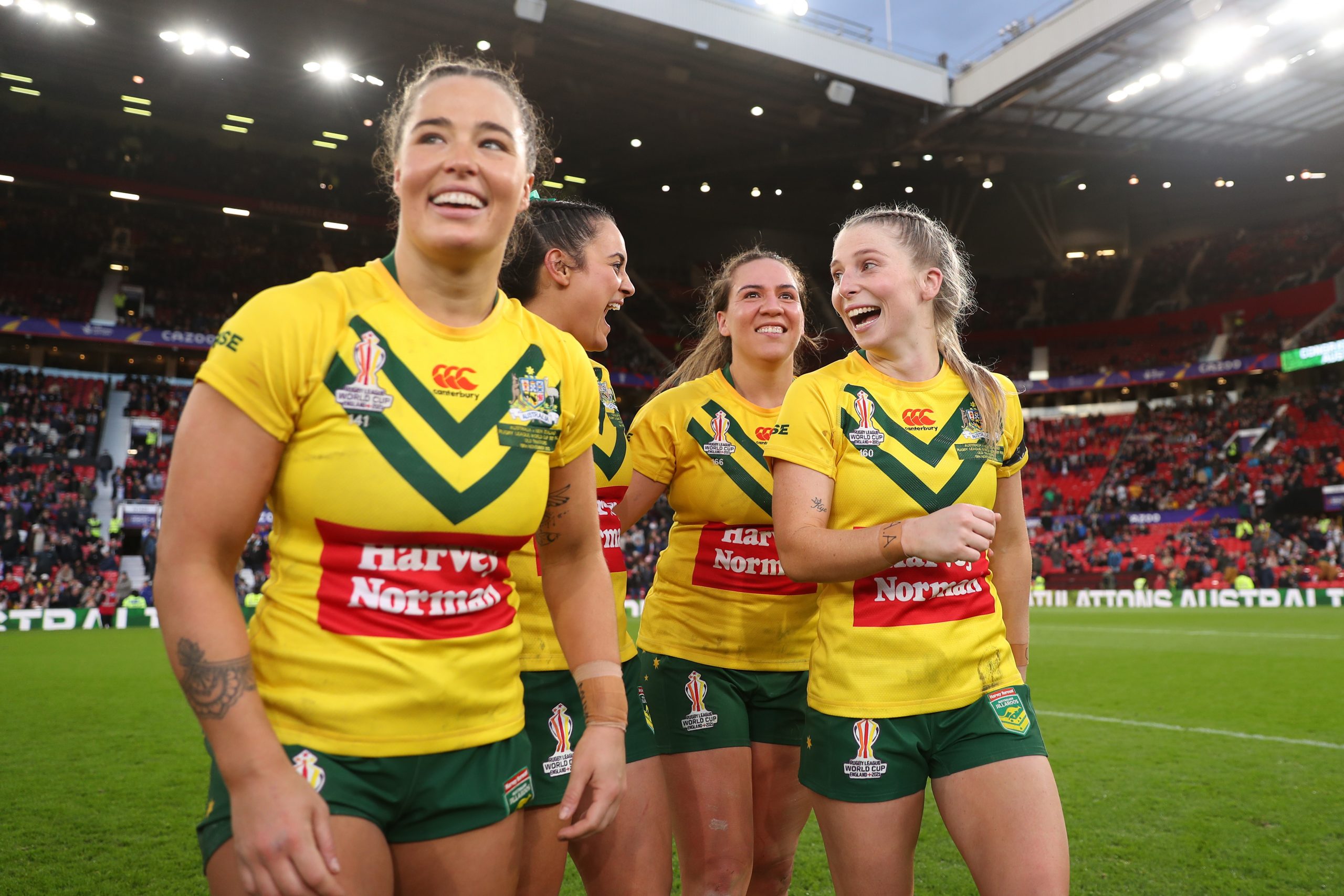 Isabelle Kelly, Yasmin Clydsdale, Evania Pelite and Tarryn Aiken of Australia celebrate following their side's victory in the Women's Rugby League World Cup Final match between Australia and New Zealand at Old Trafford on November 19, 2022 in Manchester, England. (Photo by Lewis Storey/Getty Images for RLWC)