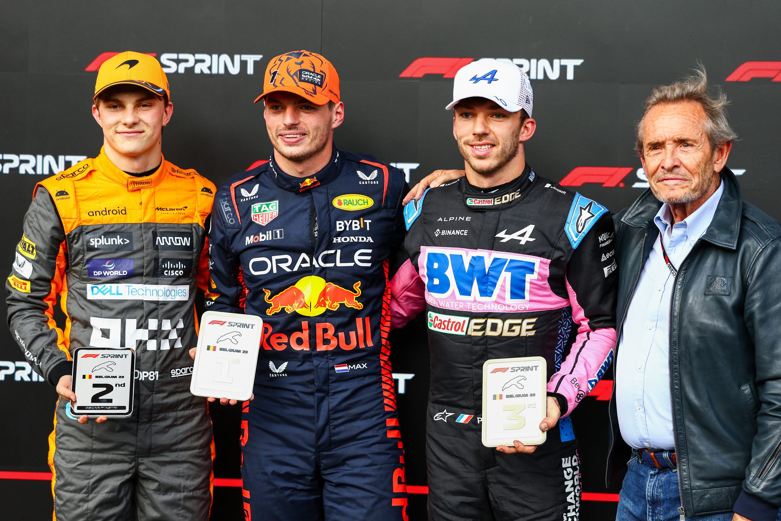 Sprint winner Max Verstappen of the Netherlands and Oracle Red Bull Racing (second from left), Second placed Oscar Piastri of Australia and McLaren (L), Third placed Pierre Gasly of France and Alpine F1 (second from right) and Jacky Ickx pose for a photo in parc ferme during the Sprint ahead of the F1 Grand Prix of Belgium at Circuit de Spa-Francorchamps on July 29, 2023 in Spa, Belgium. (Photo by Mark Thompson/Getty Images)