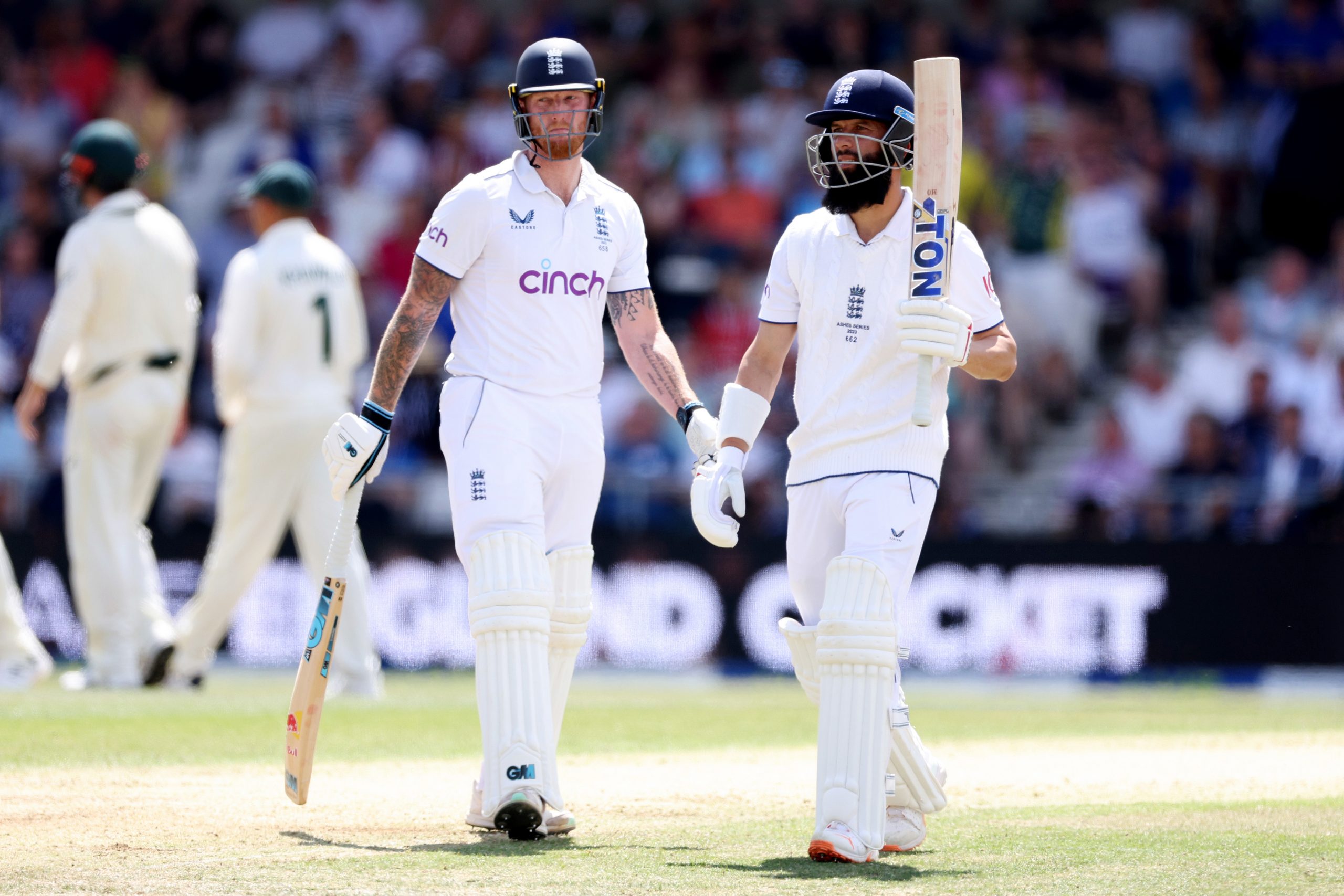 Moeen Ali (right) of England leaves the field after being dismissed by Australia captain Pat Cummins.
