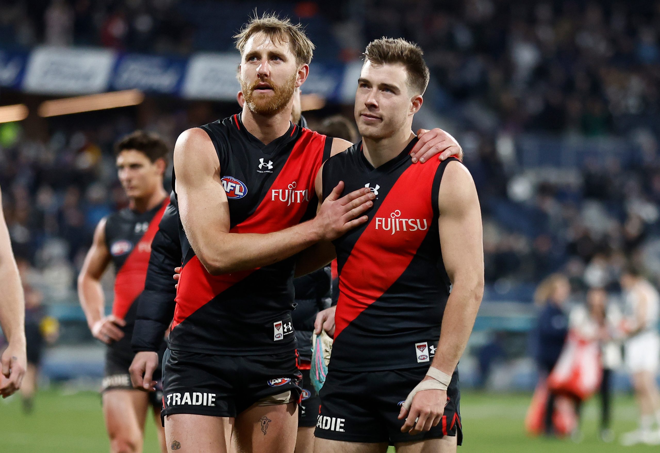 GEELONG, AUSTRALIA - JULY 15: Dyson Heppell (left) and Zach Merrett of the Bombers look dejected after a loss during the 2023 AFL Round 18 match between the Geelong Cats and the Essendon Bombers at GMHBA Stadium on July 15, 2023 in Geelong, Australia. (Photo by Michael Willson/AFL Photos via Getty Images)