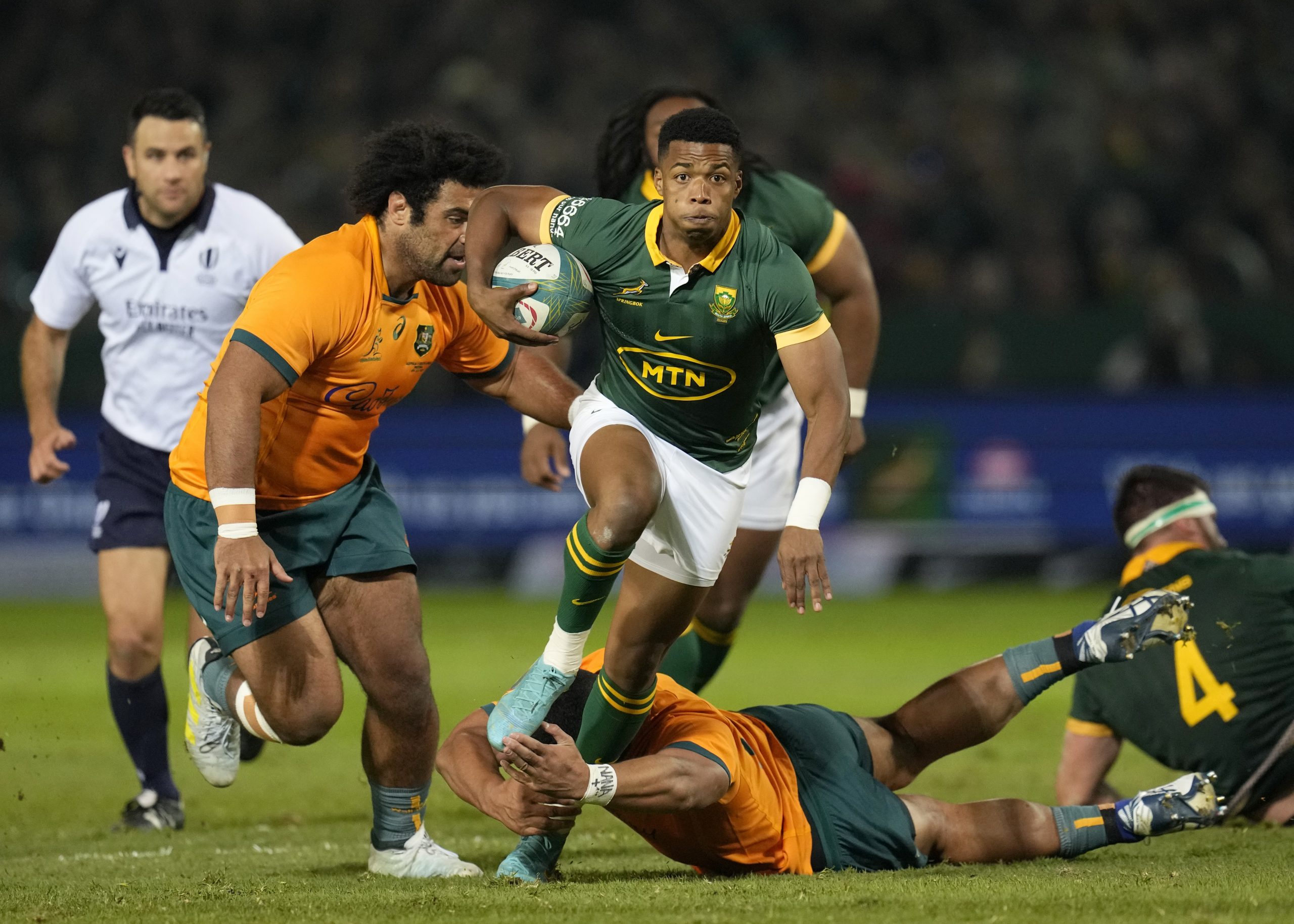 South Africa's Grant Williams jumps as he avoids a tackle from Australia's Jordan Uelese.