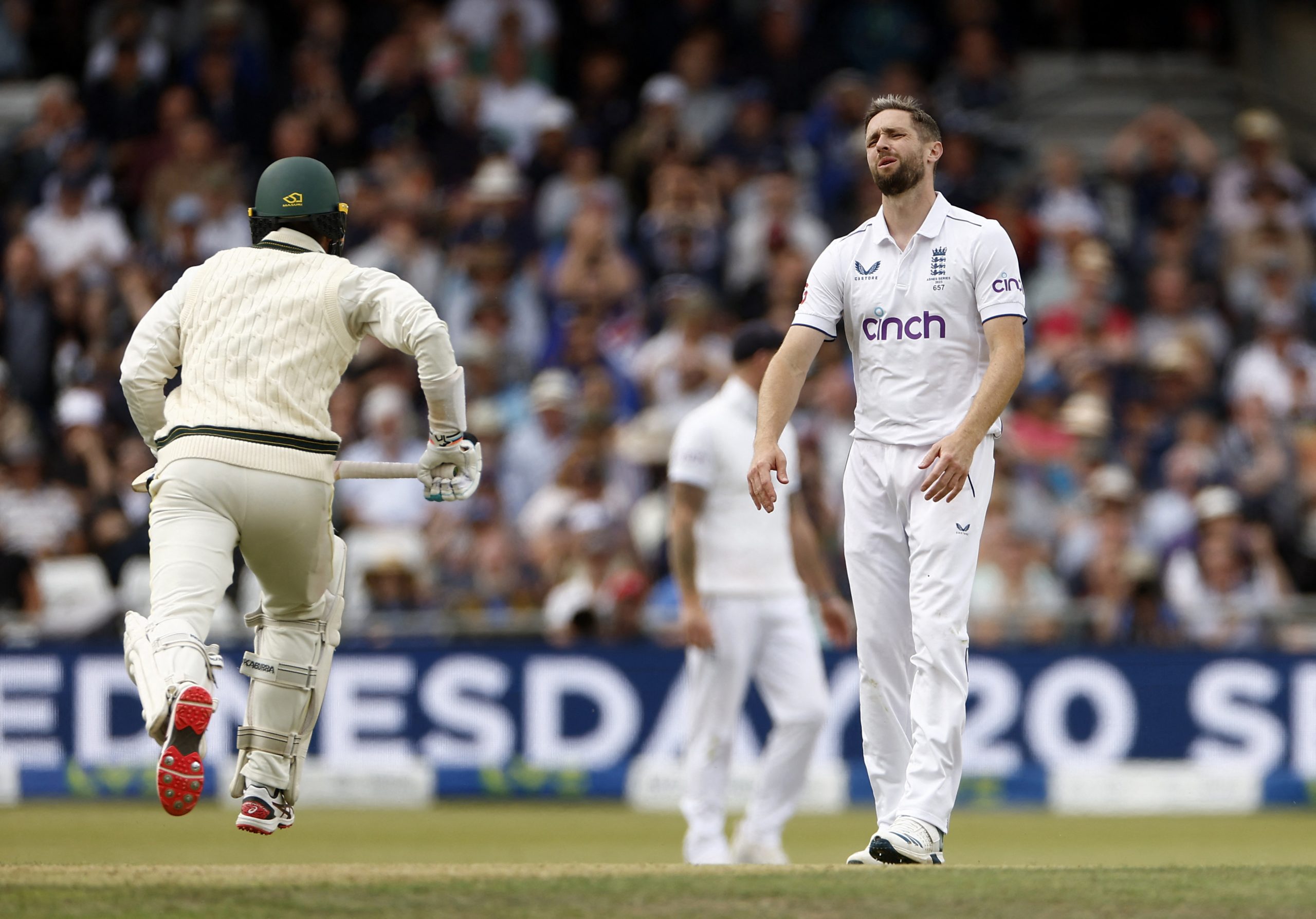 Chris Woakes reacts after Joe Root drops a catch.
