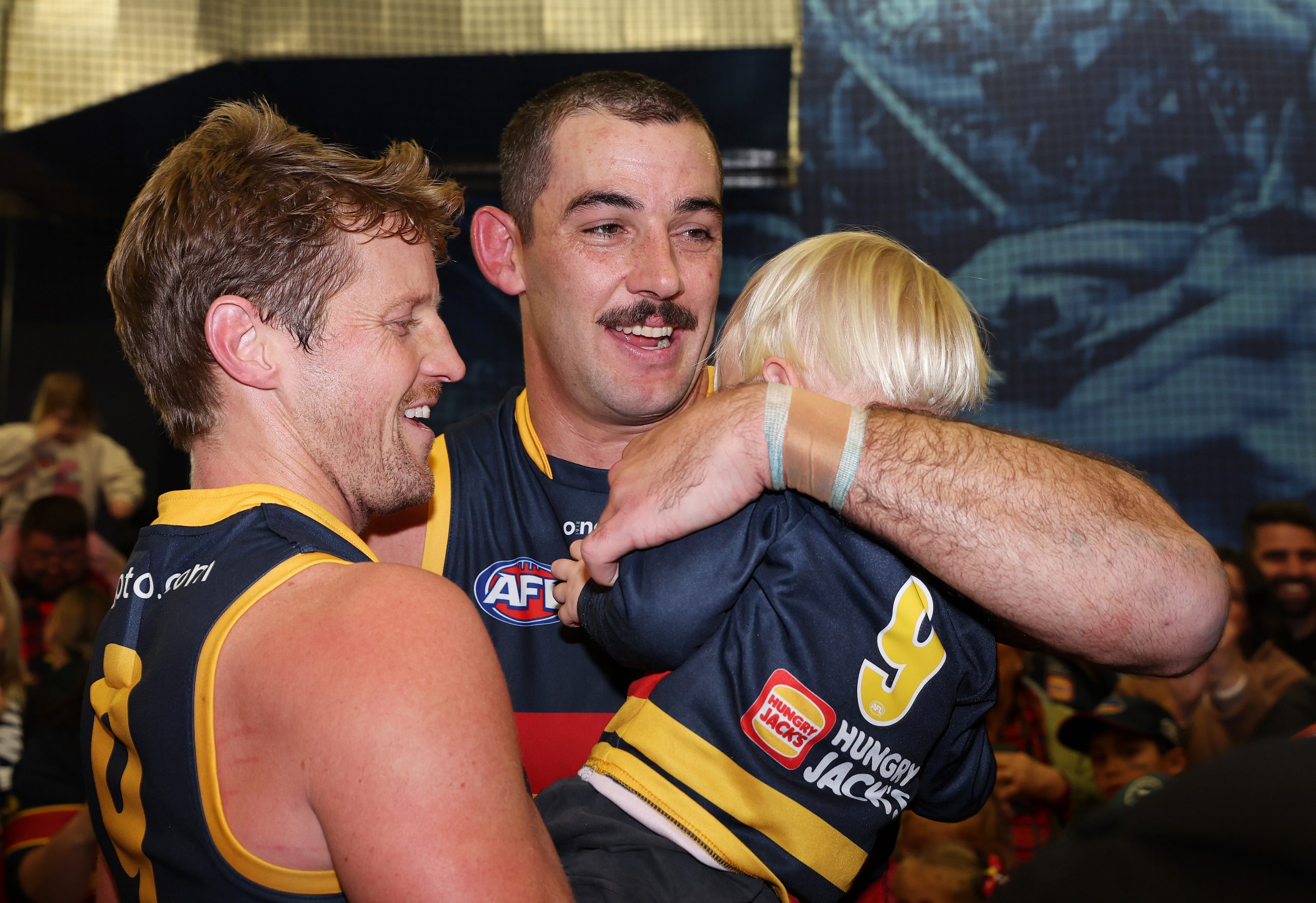 ADELAIDE, AUSTRALIA - JUNE 10: Taylor Walker of the Crows with Rory Sloane on his son after the win, 250th game and 10 goals during the 2023 AFL Round 13 match between the Adelaide Crows and the West Coast Eagles at Adelaide Oval on June 10, 2023 in Adelaide, Australia. (Photo by Sarah Reed/AFL Photos via Getty Images)