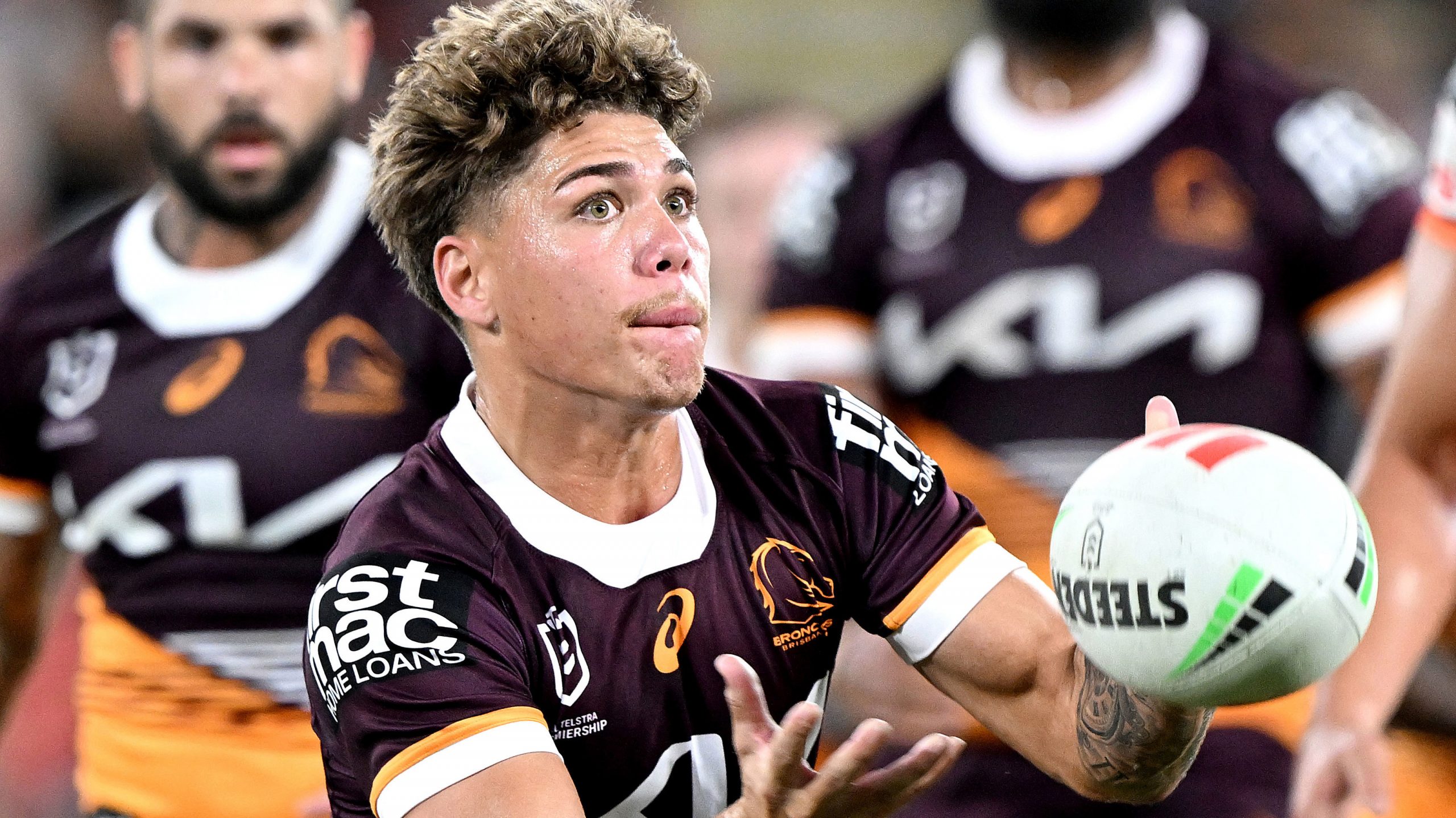 Reece Walsh of the Broncos passes the ball during their round five match against Wests Tigers. 
