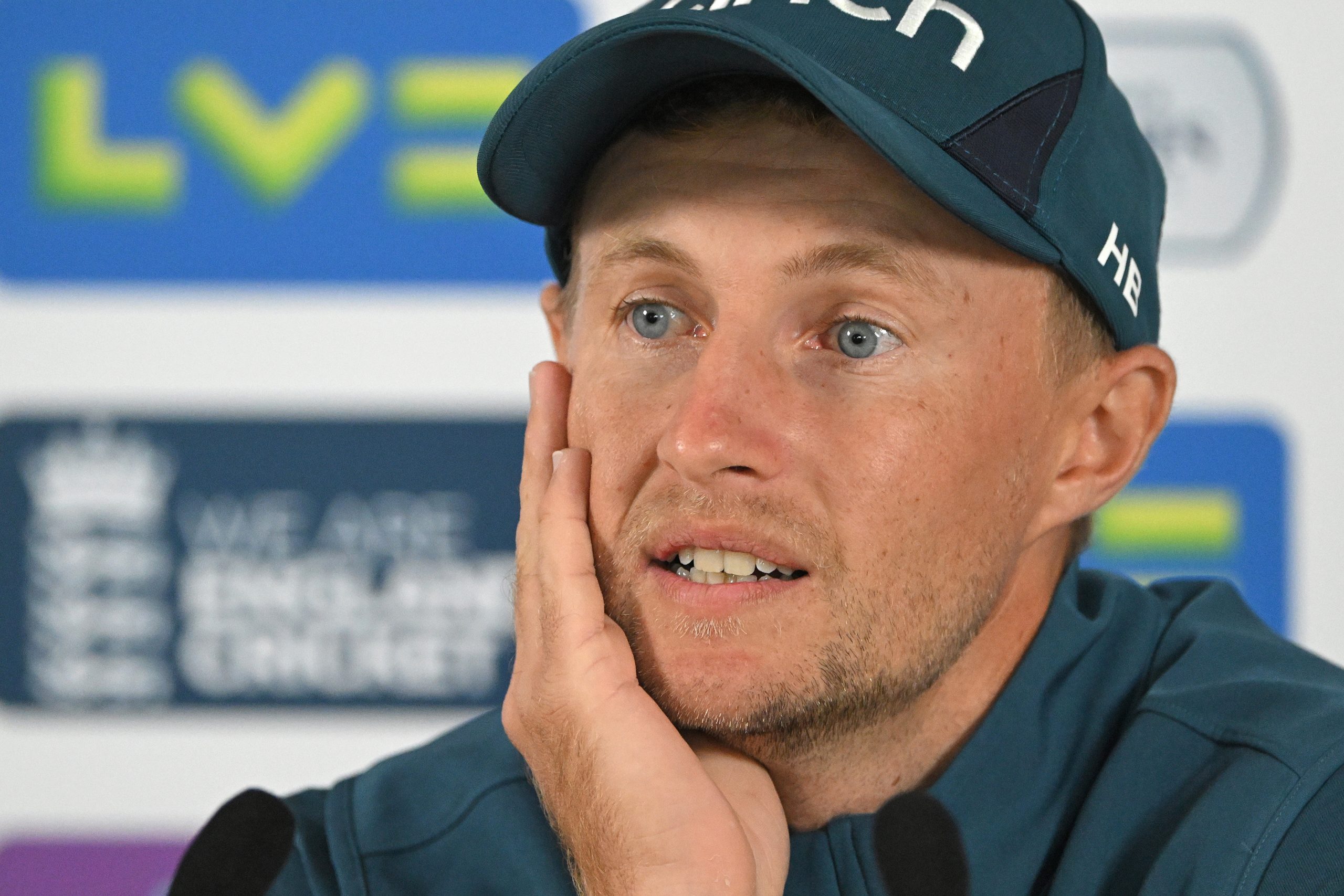 England star Joe Root faces the media.