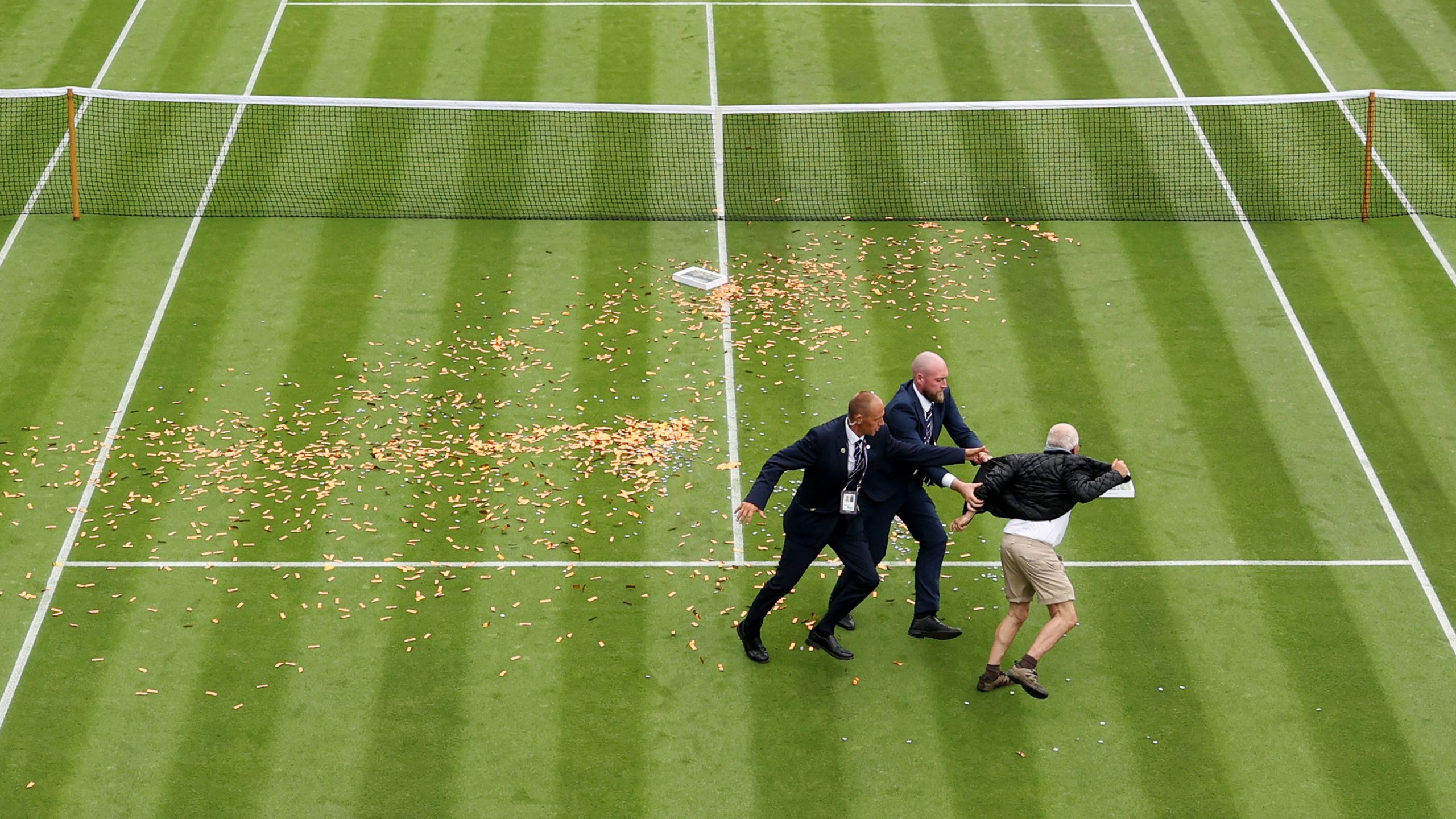 A protester trespasses on to court 18 in a Just Stop Oil protest during the Women's Singles first round match between Katie Boulter and Daria Saville. 
