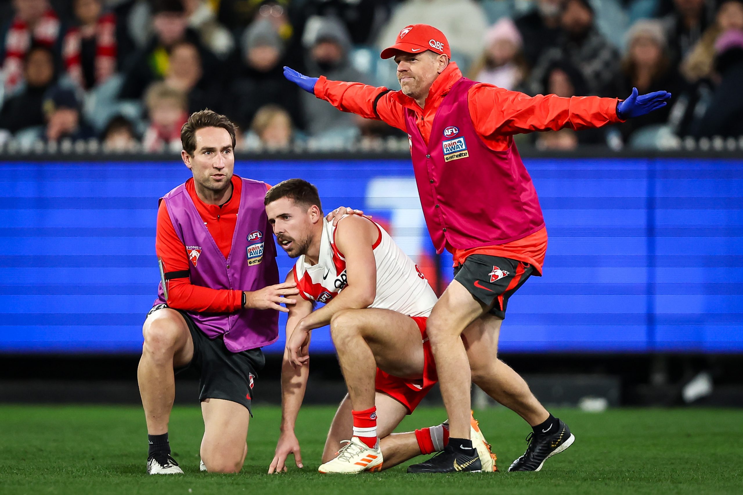MELBOURNE, AUSTRALIA - JULY 06: Jake Lloyd of the Swans appears is seen with medical staff during the 2023 AFL Round 17 match between the Richmond Tigers and the Sydney Swans at the Melbourne Cricket Ground on July 6, 2023 in Melbourne, Australia. (Photo by Dylan Burns/AFL Photos via Getty Images)
