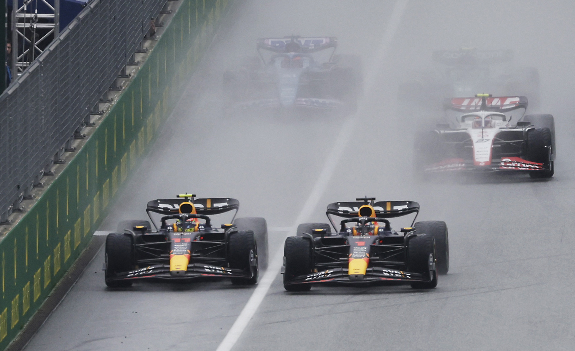 Sergio Perez (right) pushes Max Verstappen across towards the pit wall at the start of the sprint at the Austrian Grand Prix.