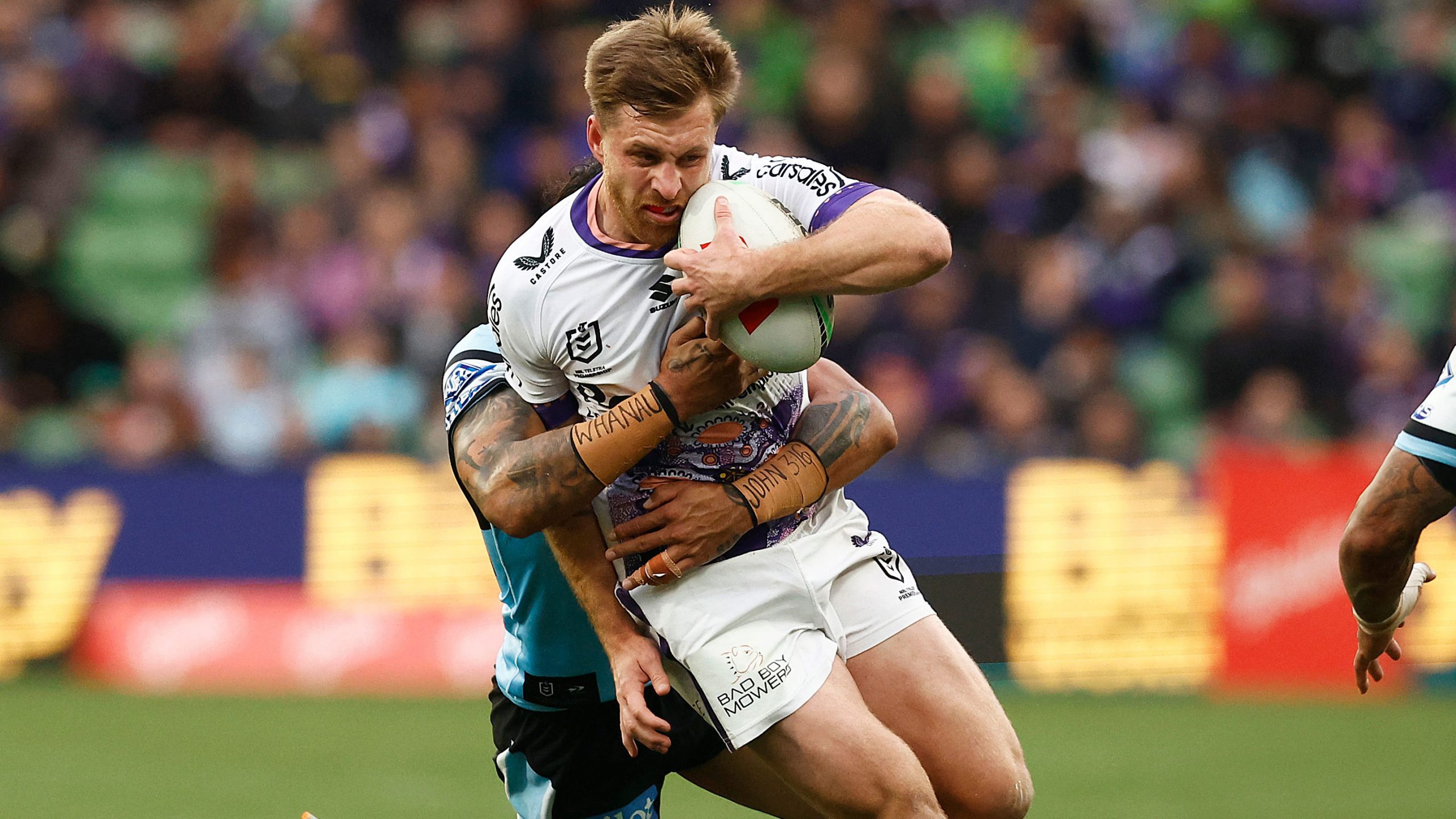 Storm star Cameron Munster is tackled by Sharks forward Briton Nikora during their round 15 clash.