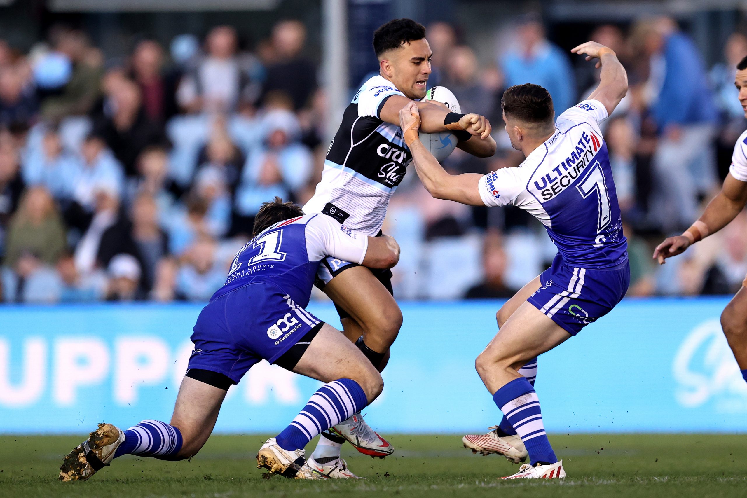 SYDNEY, AUSTRALIA - AUGUST 27: Kayal Iro of the Sharks is tackled by the Bulldogs defence during the round 24 NRL match between the Cronulla Sharks and the Canterbury Bulldogs at PointsBet Stadium, on August 27, 2022, in Sydney, Australia. (Photo by Brendon Thorne/Getty Images)