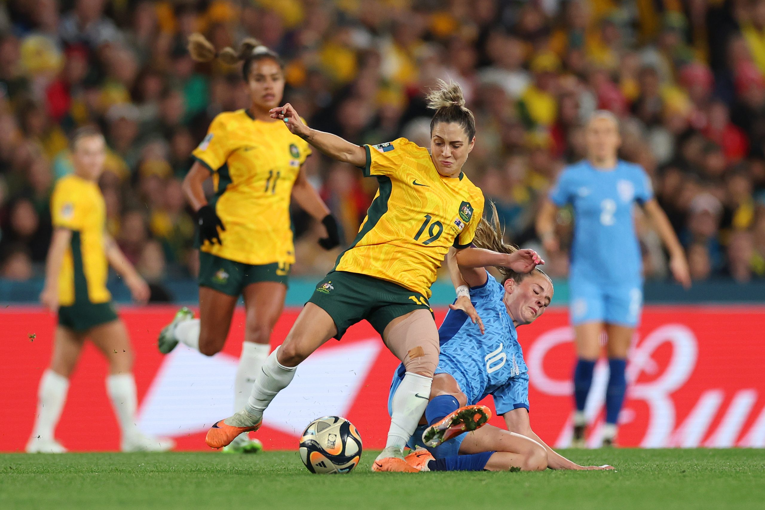 Katrina Gorry of Australia is tackled by Ella Toone of England.