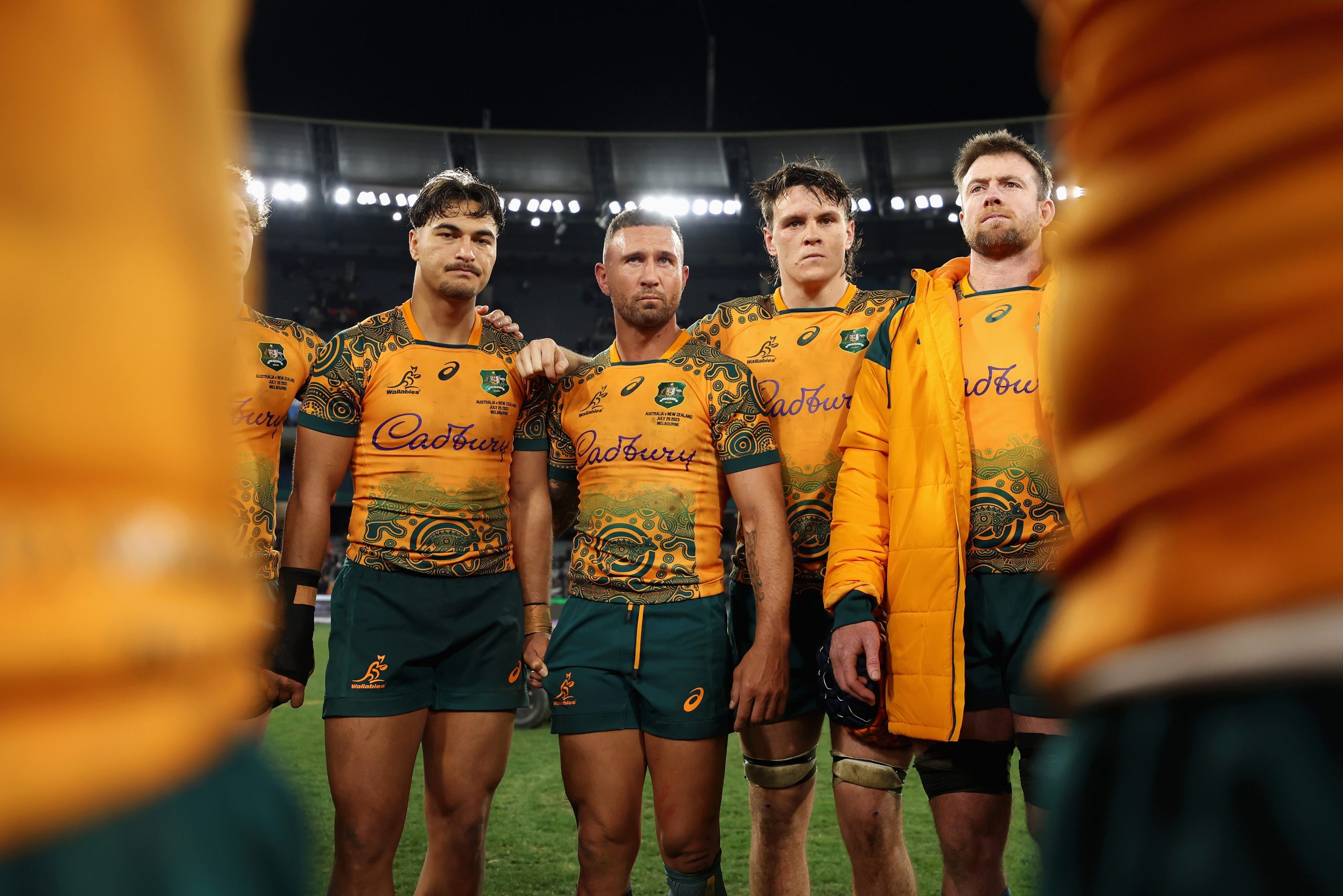 Quade Cooper of the Wallabies talks to teammates in a huddle after losing.