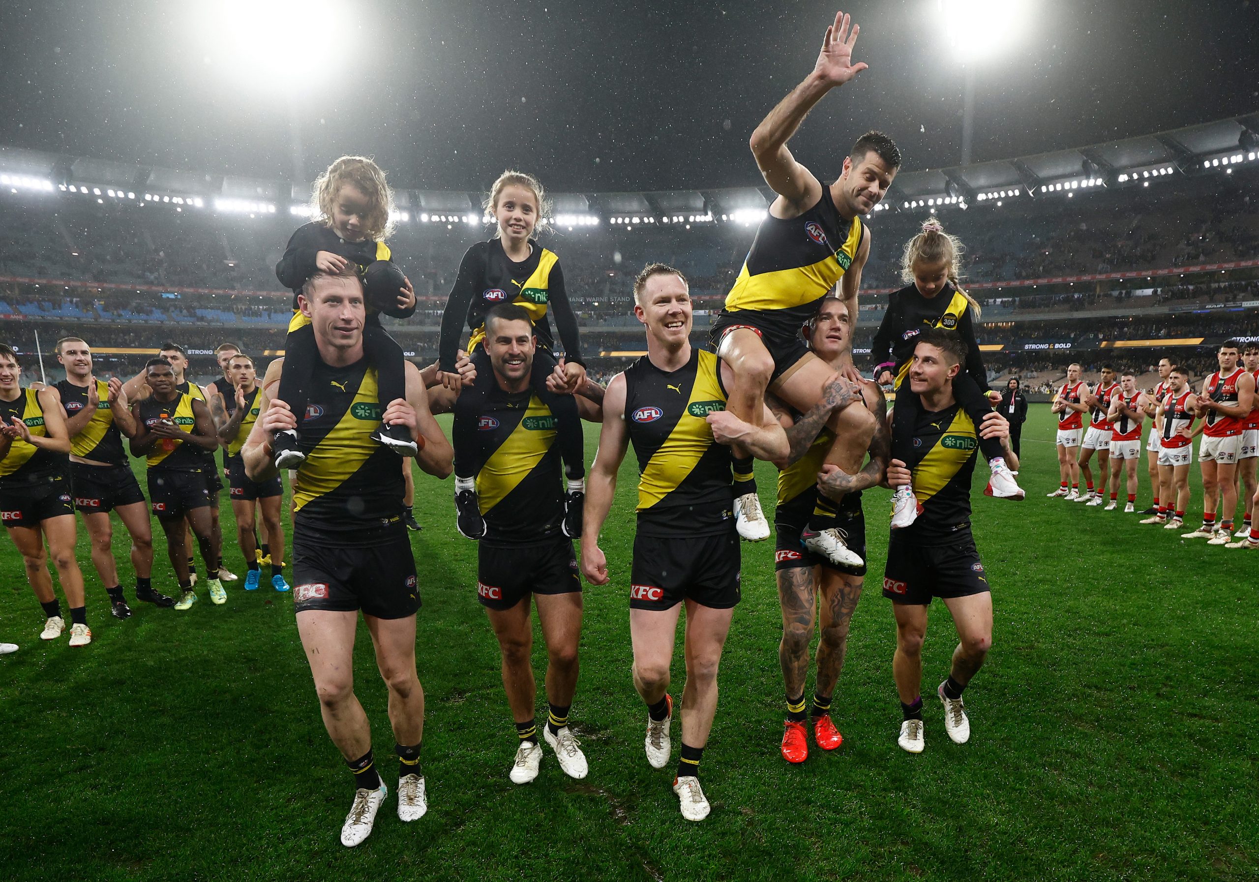 Trent Cotchin of the Tigers leaves the field after his 300th match with children Harper, Parker and Mackenzie during the 2023 AFL Round 14 match between the Richmond Tigers and the St Kilda Saints at the Melbourne Cricket Ground on June 17, 2023 in Melbourne, Australia. (Photo by Michael Willson/AFL Photos via Getty Images)