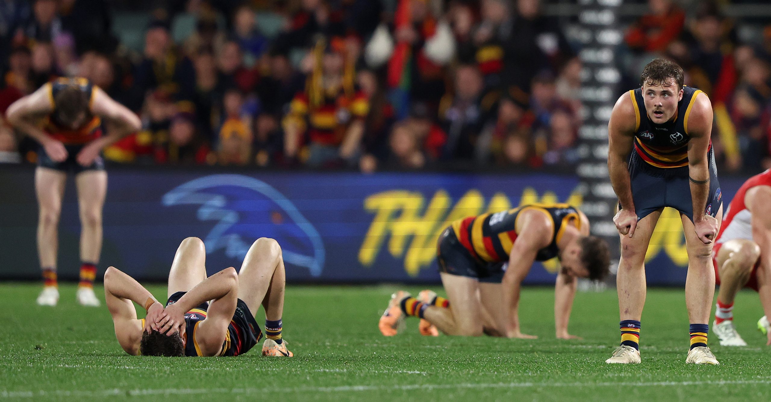 Luke Pedlar and Crows teammates after their devastating loss to Sydney.