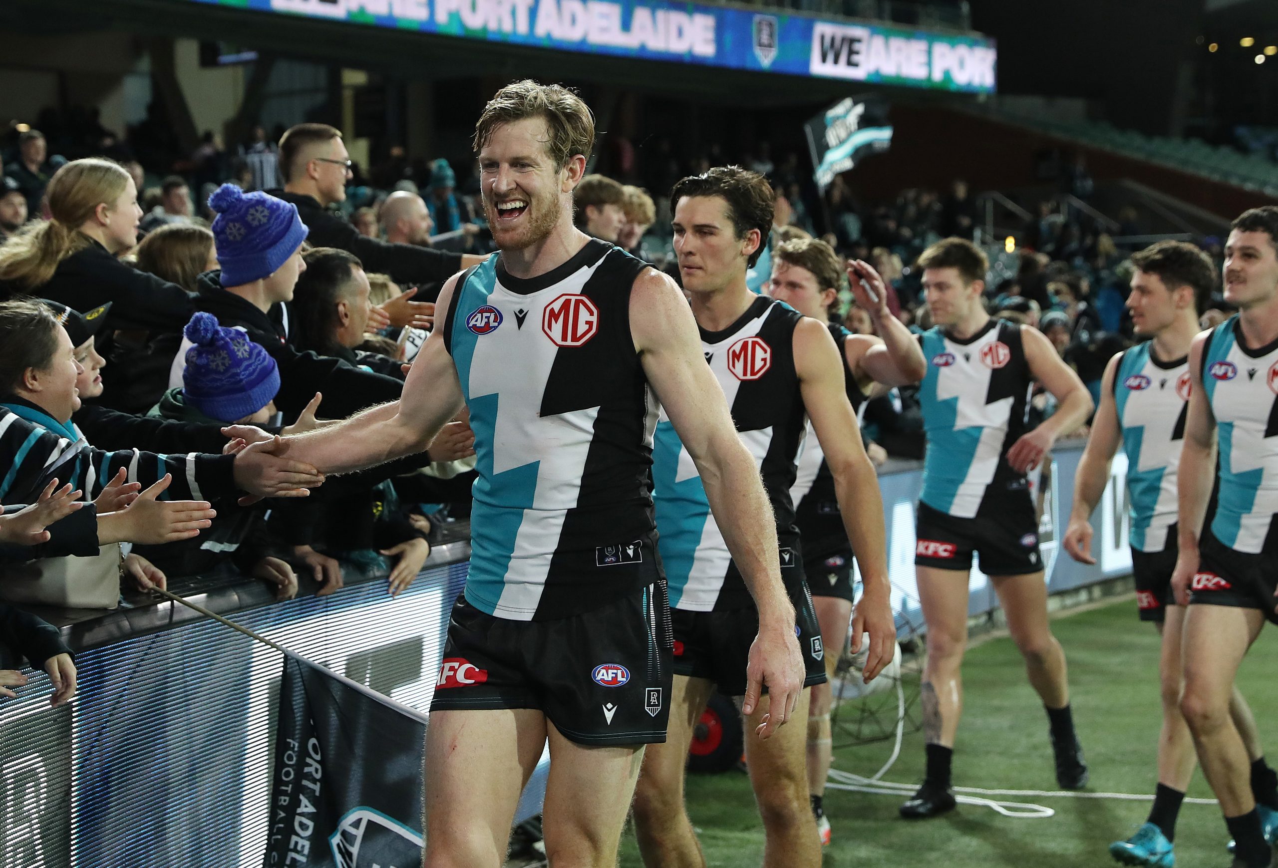 ADELAIDE, AUSTRALIA - AUGUST 13: Tom Jonas of the Power with fans after the win during the 2023 AFL Round 22 match between the Port Adelaide Power and the GWS GIANTS at Adelaide Oval on August 13, 2023 in Adelaide, Australia. (Photo by Sarah Reed/AFL Photos via Getty Images)