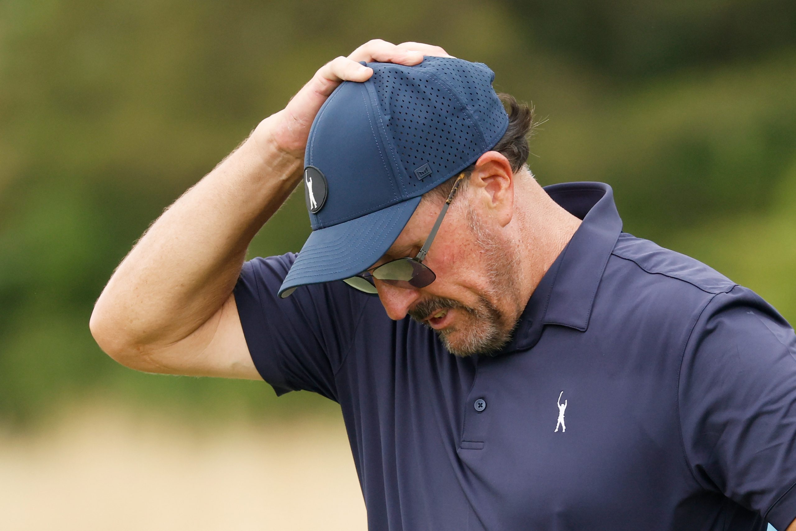 Phil Mickelson reacts on the 14th green during day one of the LIV Golf Invitational in Bedminster.