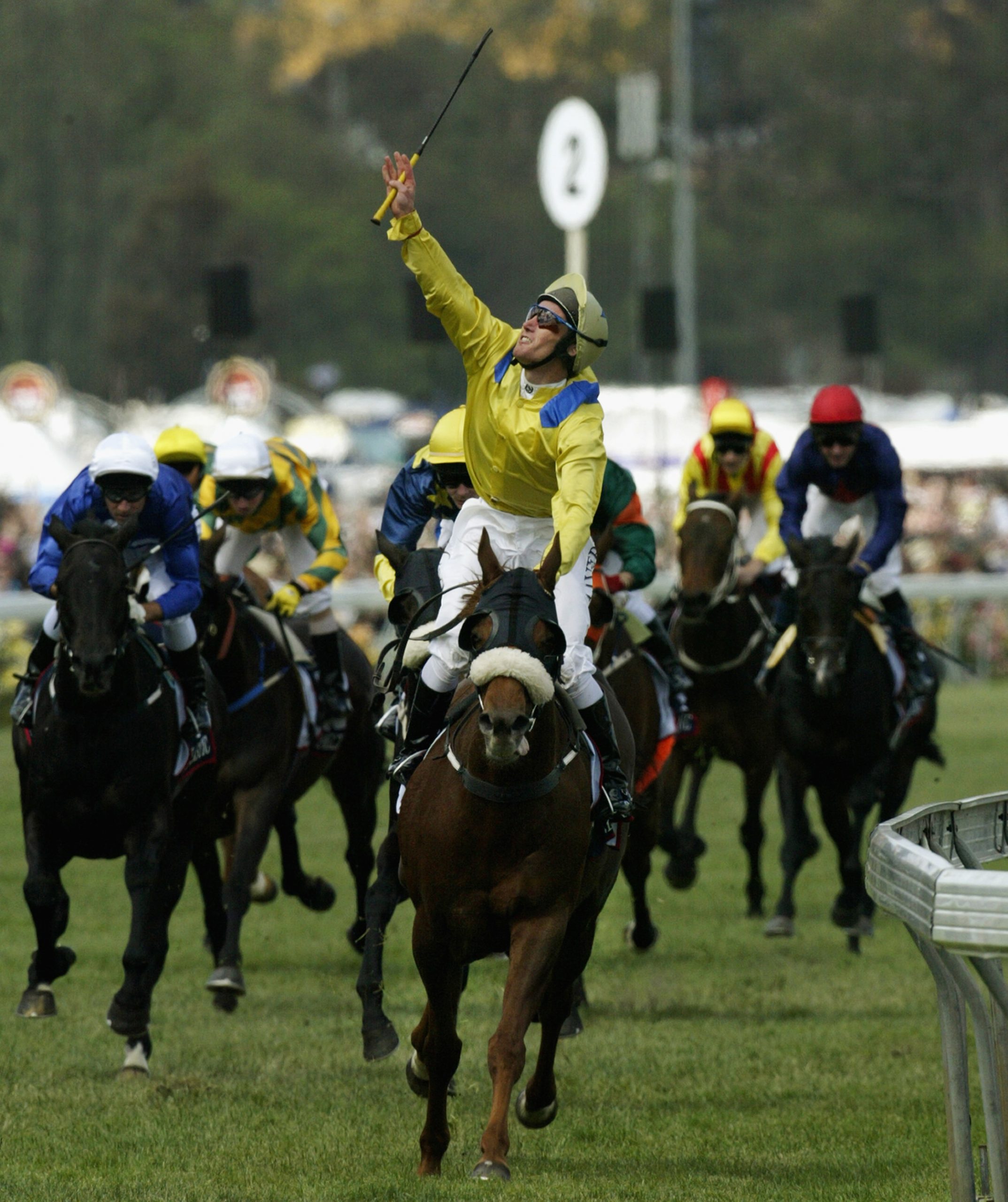 MELBOURNE - NOVEMBER 5:  Damien Oliver celebrates on 'Media Puzzle' after winning the 2002 Tooheys New Melbourne Cup at Flemington Racecourse in Melbourne, Australia on November 5, 2002. (Photo by Adam Pretty/Getty Images)