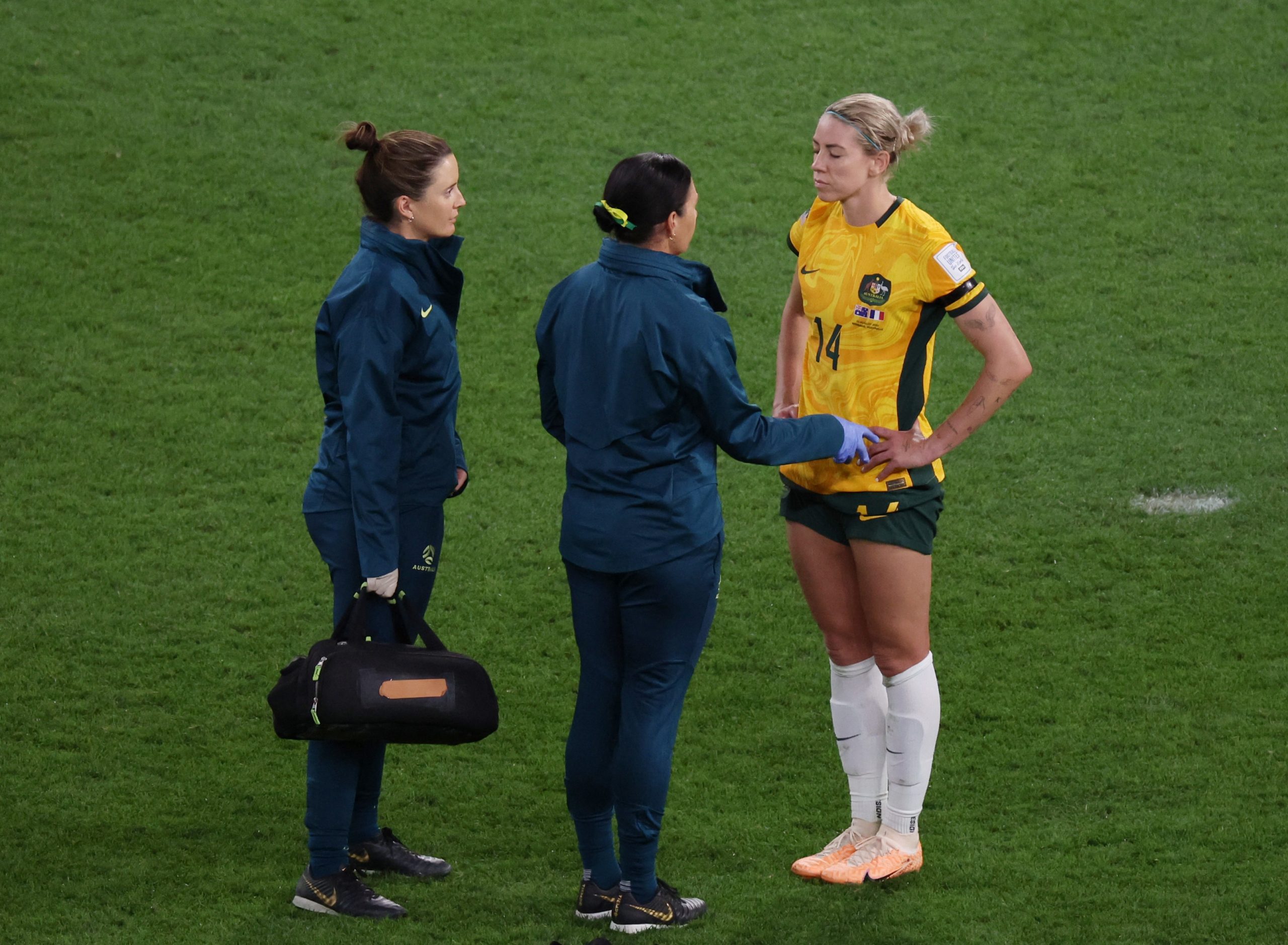 Alanna Kennedy receives medical attention after a head clash.