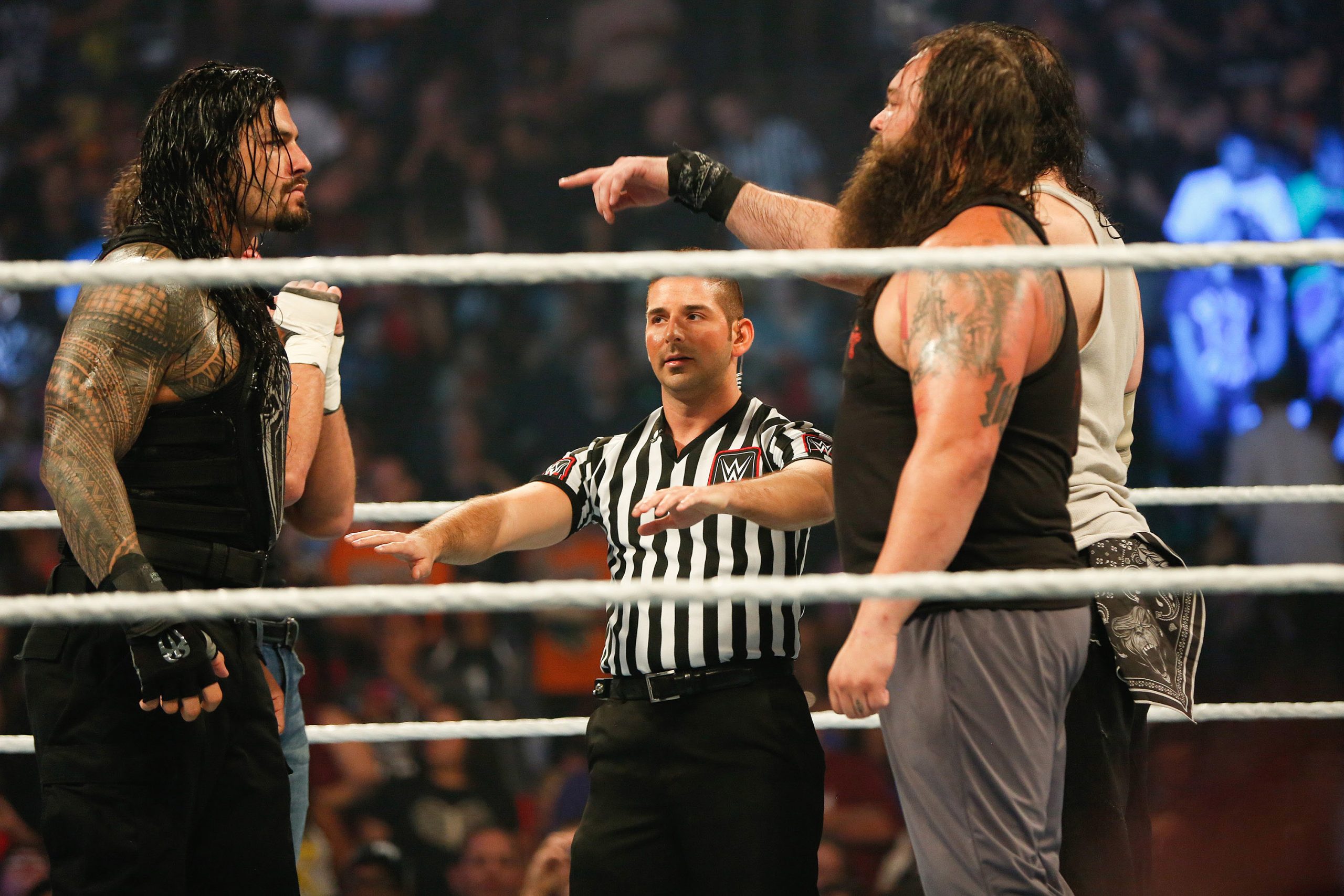 Roman Reigns and Bray Wyatt stare each other down at the WWE SummerSlam 2015.