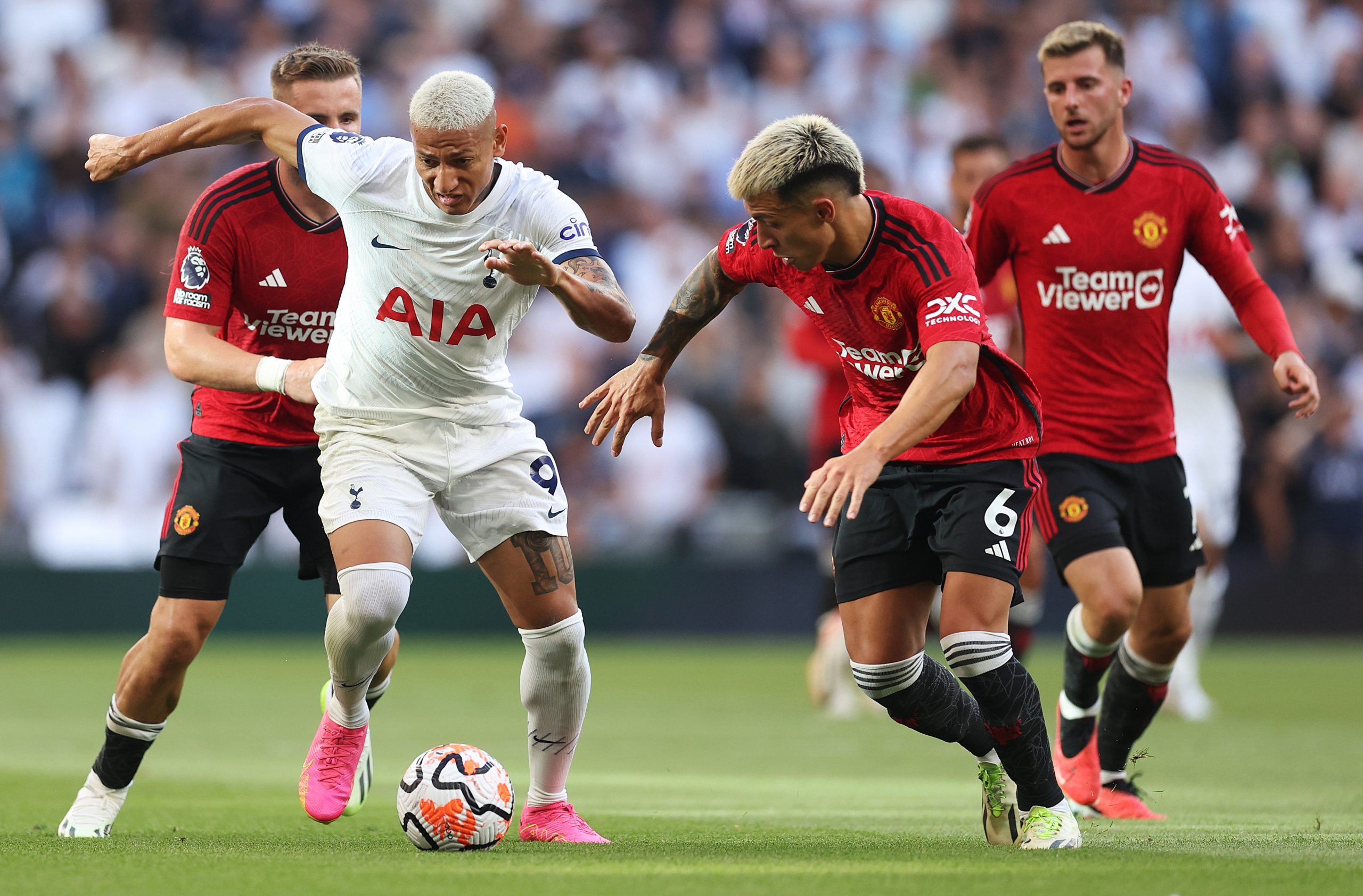 Richarlison of Tottenham Hotspur controls the ball whilst under pressure from Lisandro Martinez of Manchester United during the Premier League match between Tottenham Hotspur and Manchester United at Tottenham Hotspur Stadium on August 19, 2023 in London, England. (Photo by Julian Finney/Getty Images)