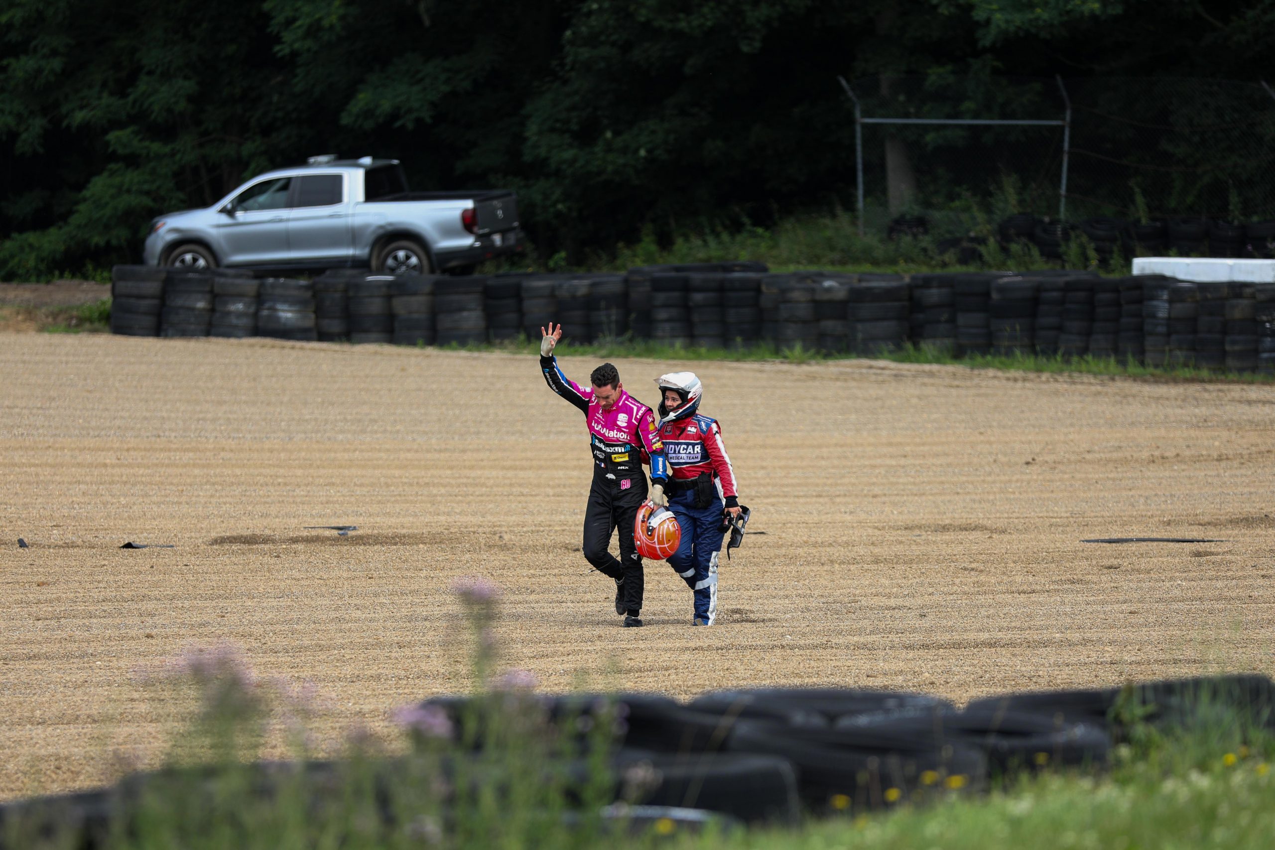 Simon Pagenaud walks away from his wrecked IndyCar.
