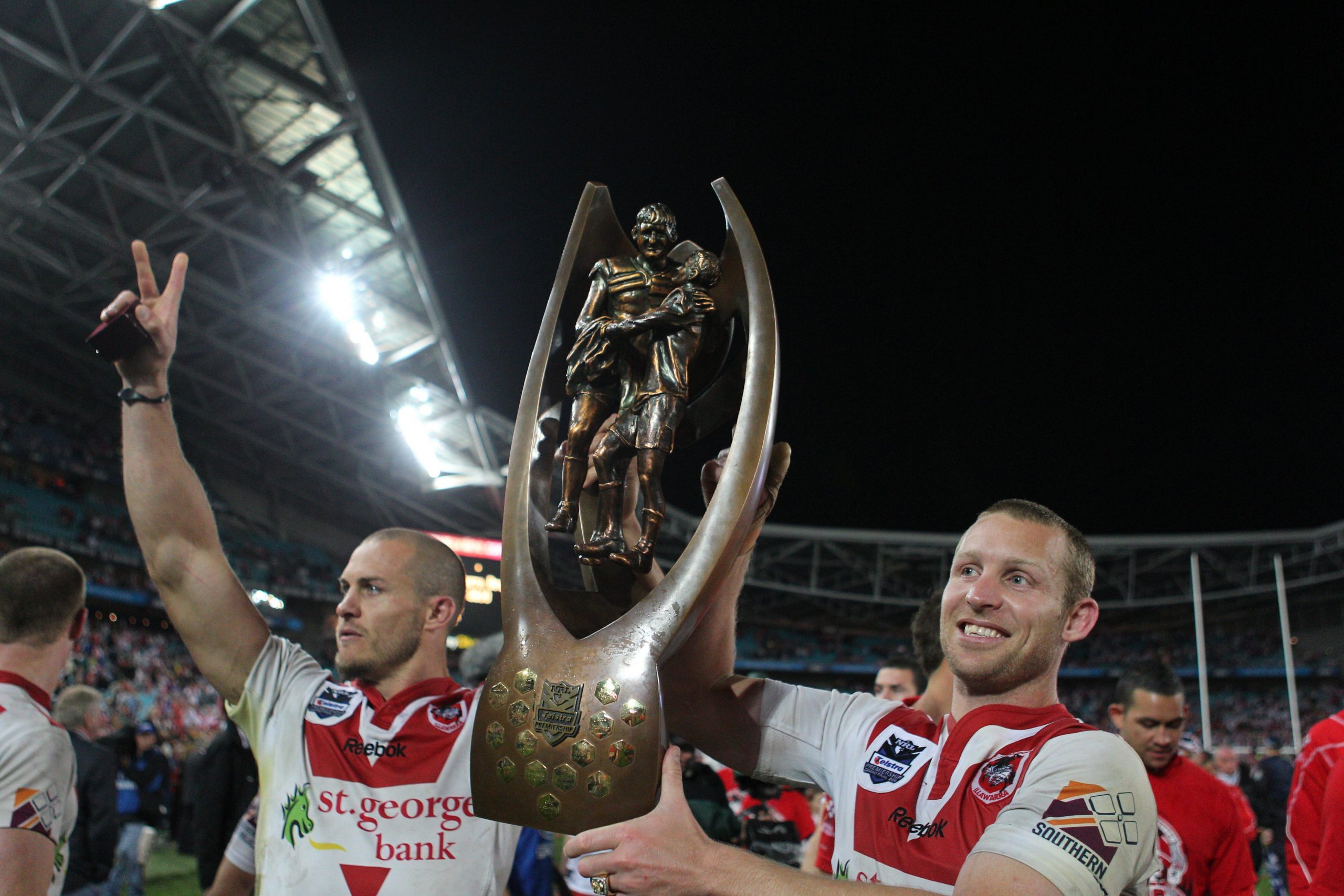 Ben Hornby (right) and Matt Cooper lift the NRL premiership trophy.