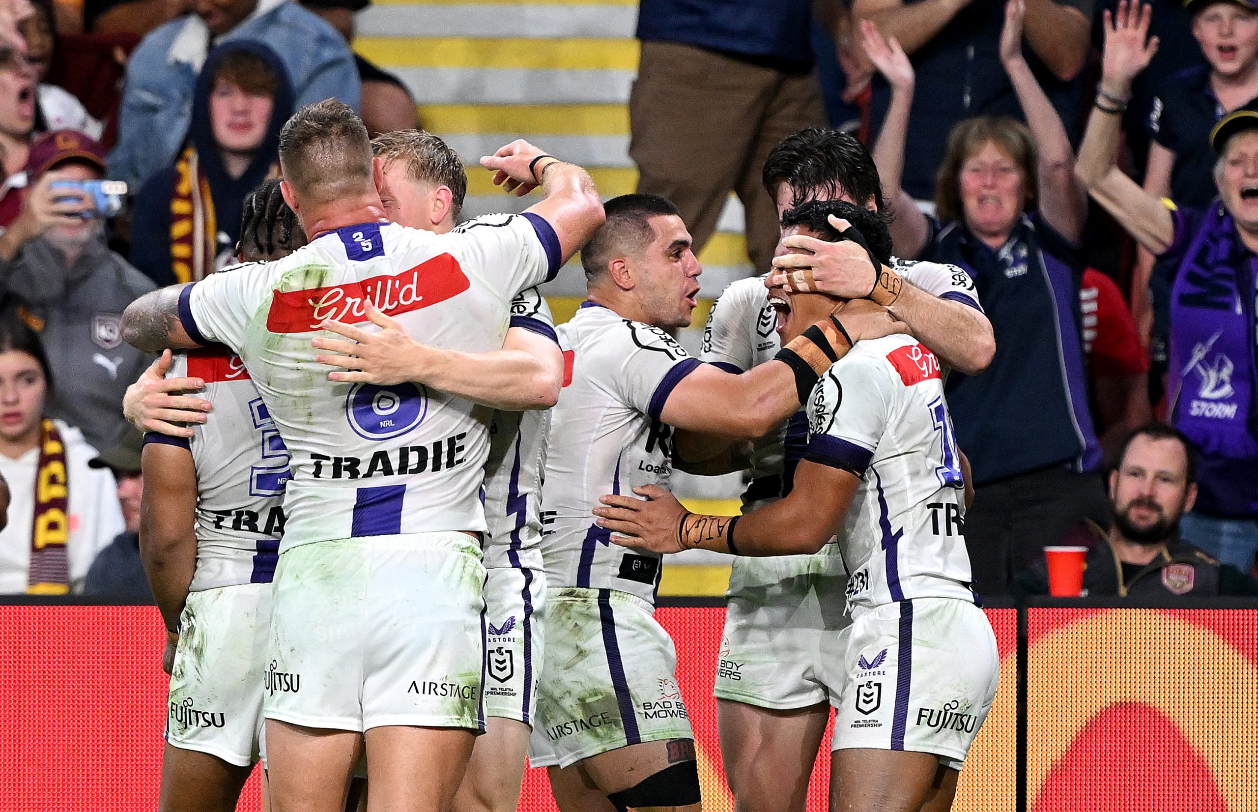 BRISBANE, AUSTRALIA - AUGUST 31: Sualauvi Faalogo of the Storm celebrates with team mates after scoring a try during the round 27 NRL match between the Brisbane Broncos and Melbourne Storm at Suncorp Stadium on August 31, 2023 in Brisbane, Australia. (Photo by Bradley Kanaris/Getty Images)