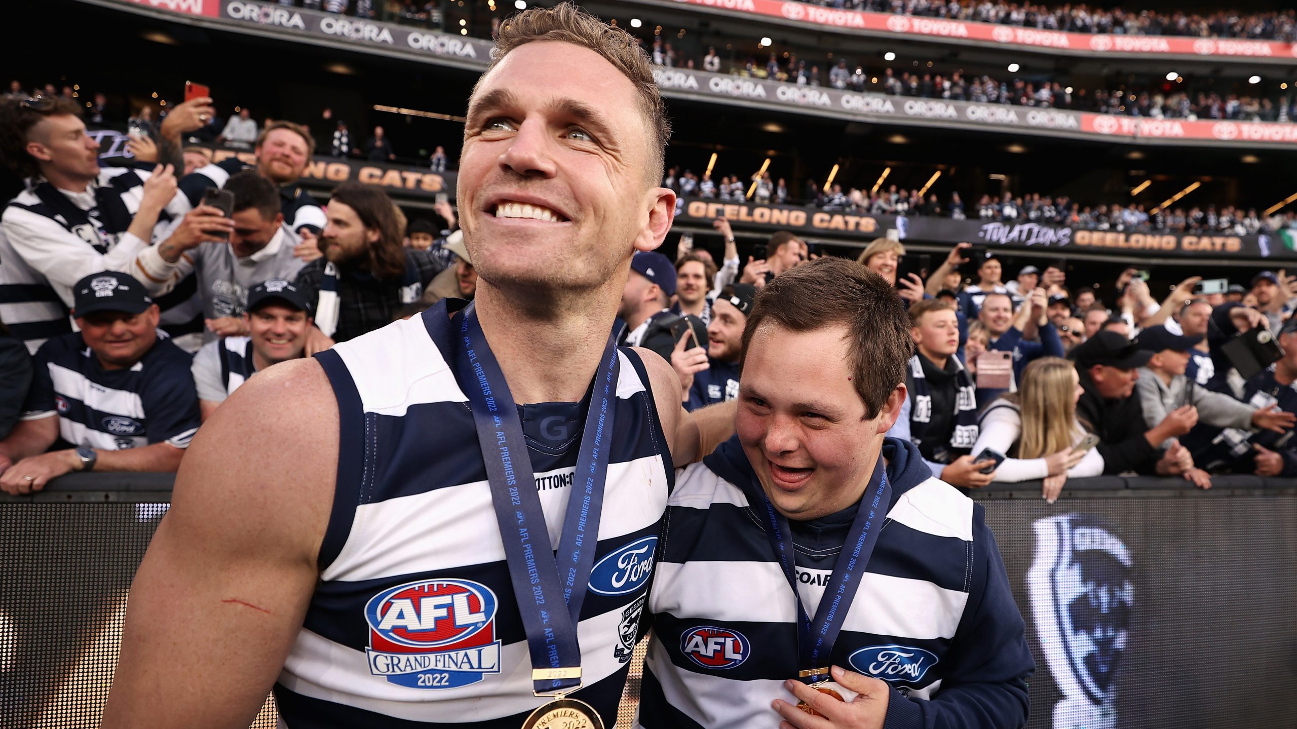 Joel Selwood of the Cats celebrates with Cats head waterboy Sam Moorfoot after winning the 2022 AFL Grand Final match between the Geelong Cats and the Sydney Swans at the Melbourne Cricket Ground on September 24, 2022 in Melbourne, Australia. (Photo by Cameron Spencer/AFL Photos/via Getty Images)