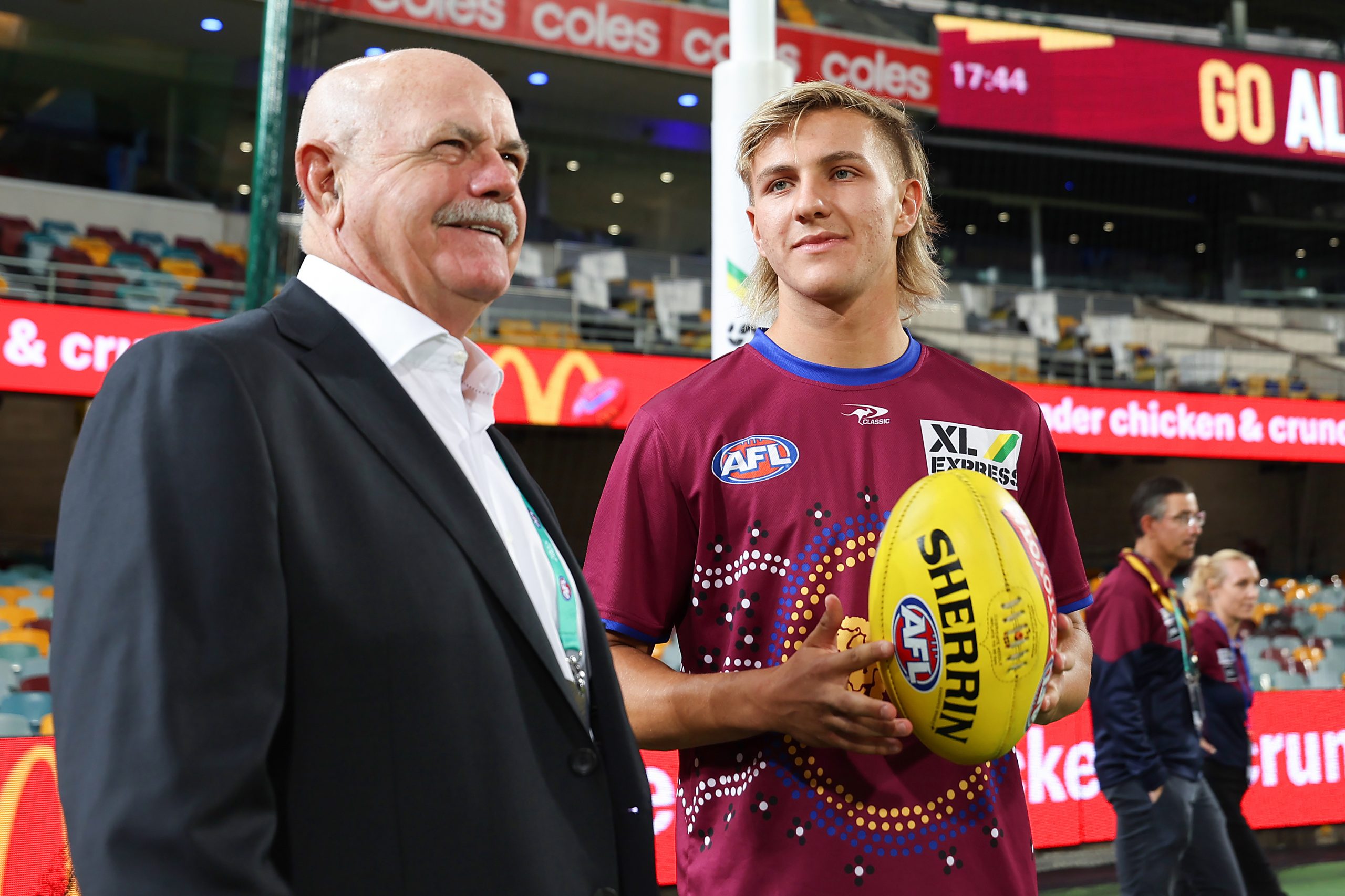 Brisbane's Kai Lohmann of the Lions speaks to Leigh Matthews before his debut.