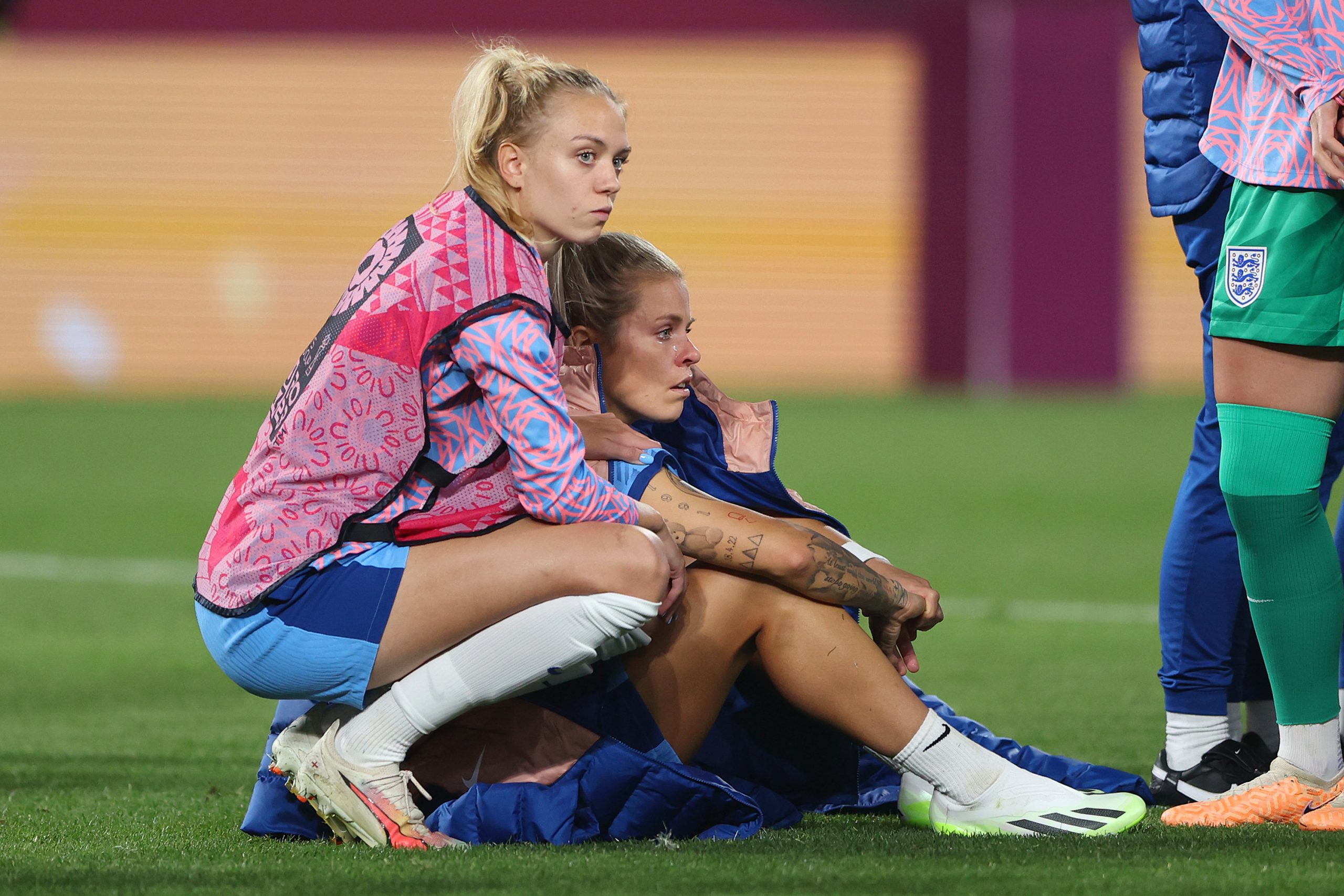 Rachel Daly and Esme Morgan of England look dejected after the team's defeat.