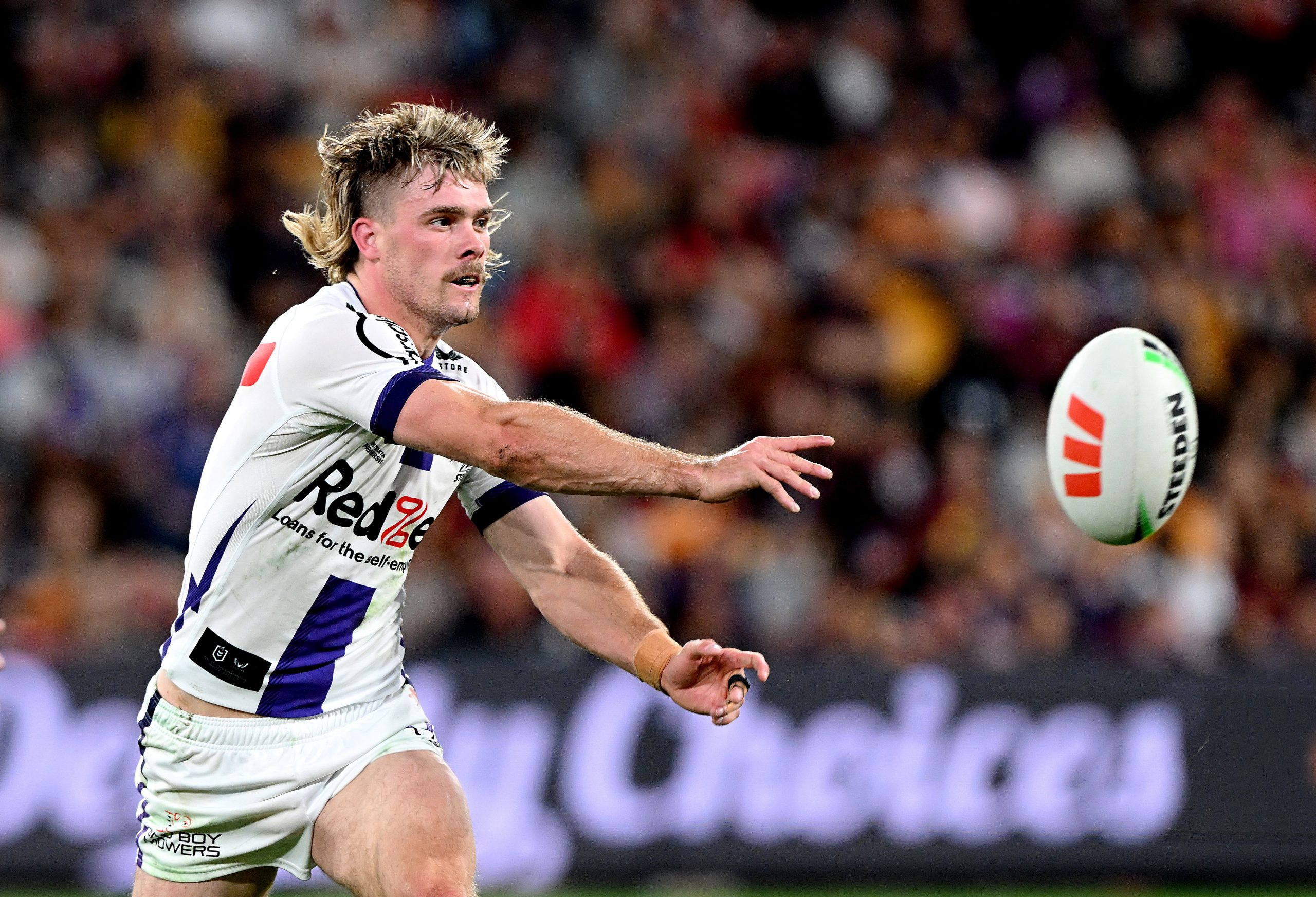 BRISBANE, AUSTRALIA - AUGUST 31: Ryan Papenhuyzen of the Storm passes the ball during the round 27 NRL match between the Brisbane Broncos and Melbourne Storm at Suncorp Stadium on August 31, 2023 in Brisbane, Australia. (Photo by Bradley Kanaris/Getty Images)