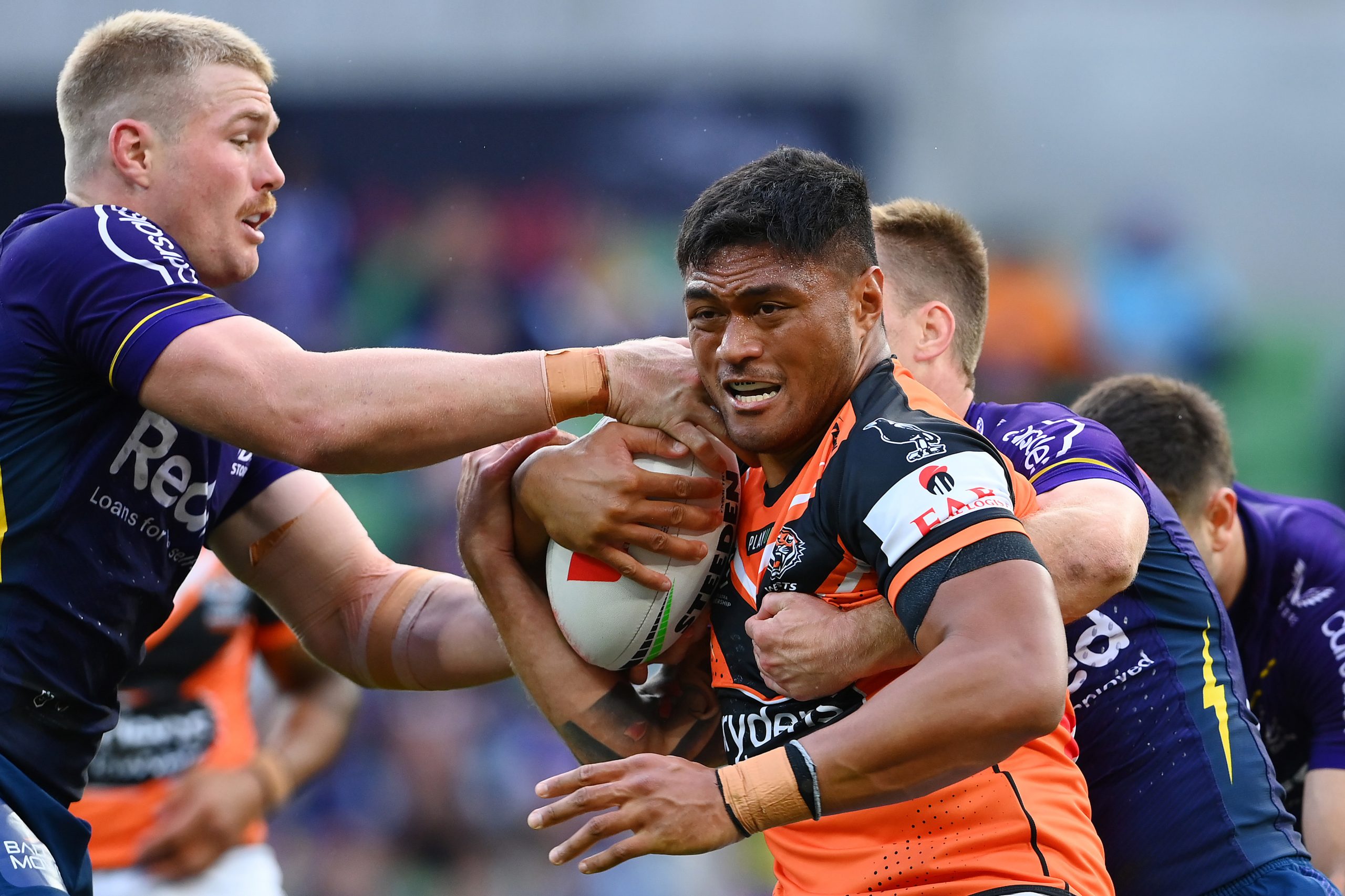 MELBOURNE, AUSTRALIA - MARCH 24:  Stefano Utoikamanu of the Wests Tigers is tackled during the round four NRL match between the Melbourne Storm and Wests Tigers at AAMI Park on March 24, 2023 in Melbourne, Australia. (Photo by Quinn Rooney/Getty Images)