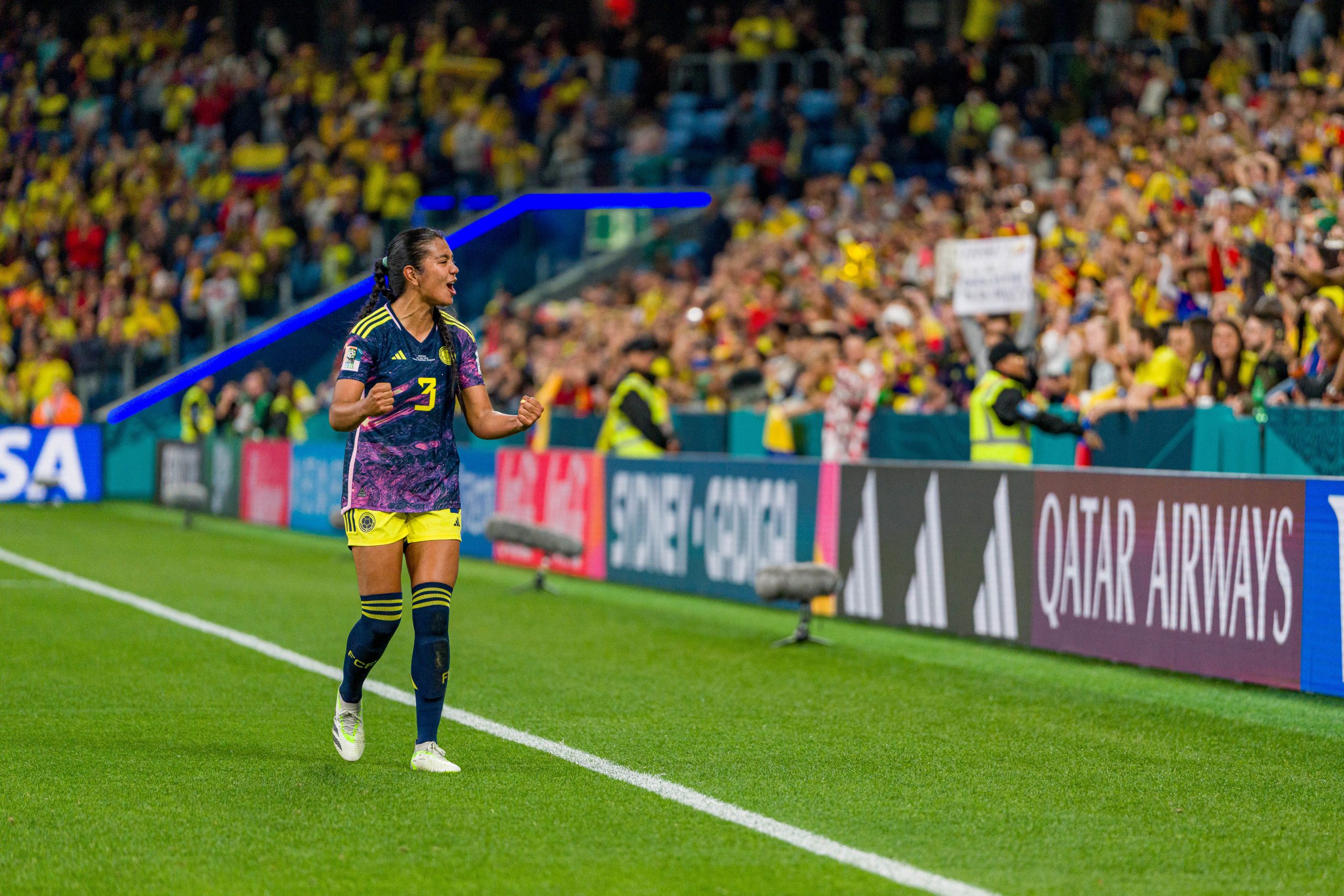 Columbia supporters get to their feet after the team's group match win over Germany.