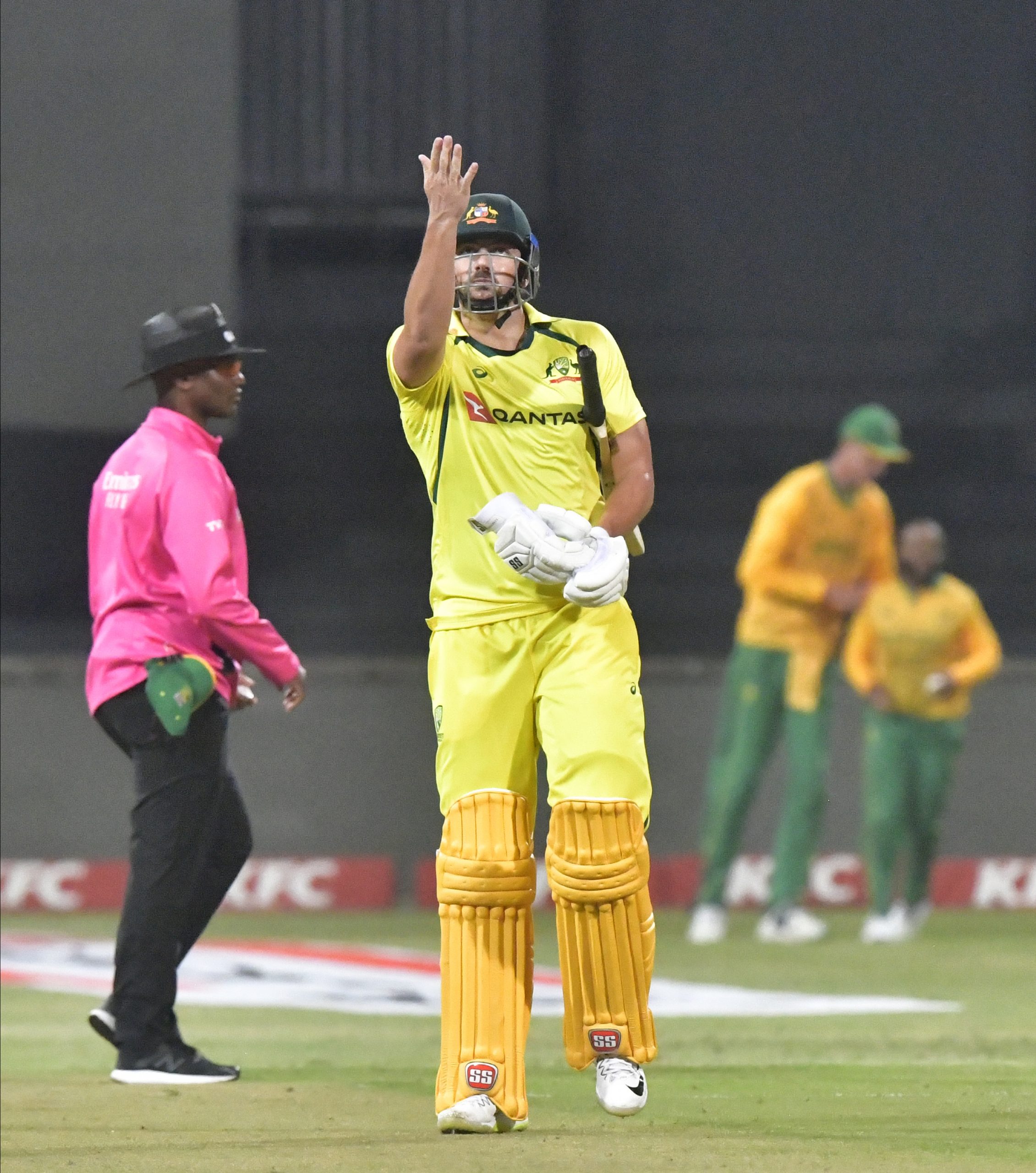 Tim David of Australia leaves the field as Temba Bavuma of South Africa celebrates his dismissal.