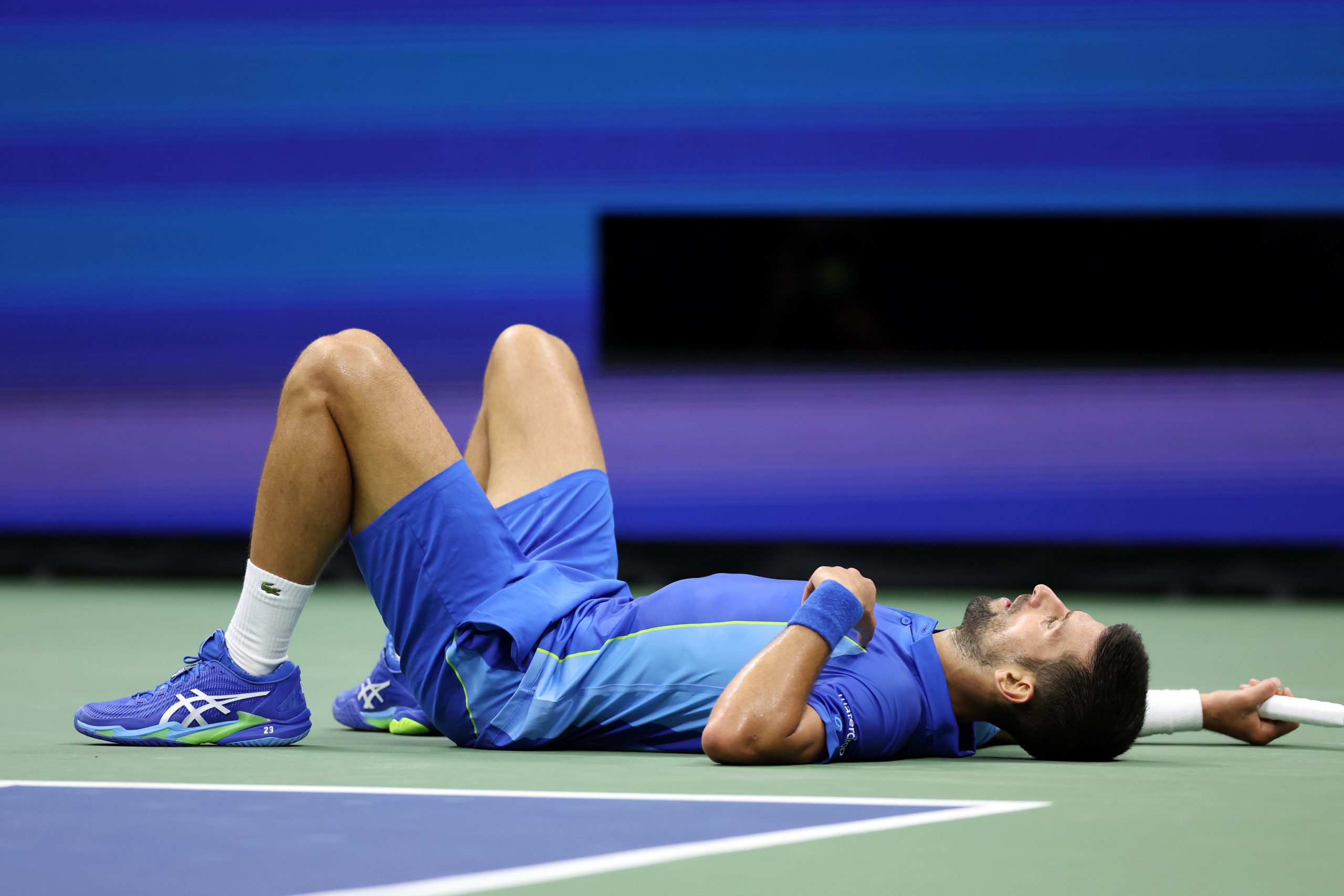 Novak Djokovic of Serbia falls down after a point against Daniil Medvedev of Russia during their Men's Singles Final match on Day Fourteen of the 2023 US Open at the USTA Billie Jean King National Tennis Center on September 10, 2023 in the Flushing neighborhood of the Queens borough of New York City. (Photo by Matthew Stockman/Getty Images)