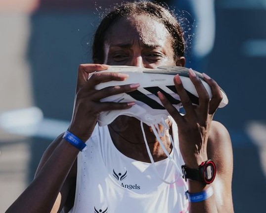 Tigst Assefa kisses her shoe after obliterating the women's marathon record.