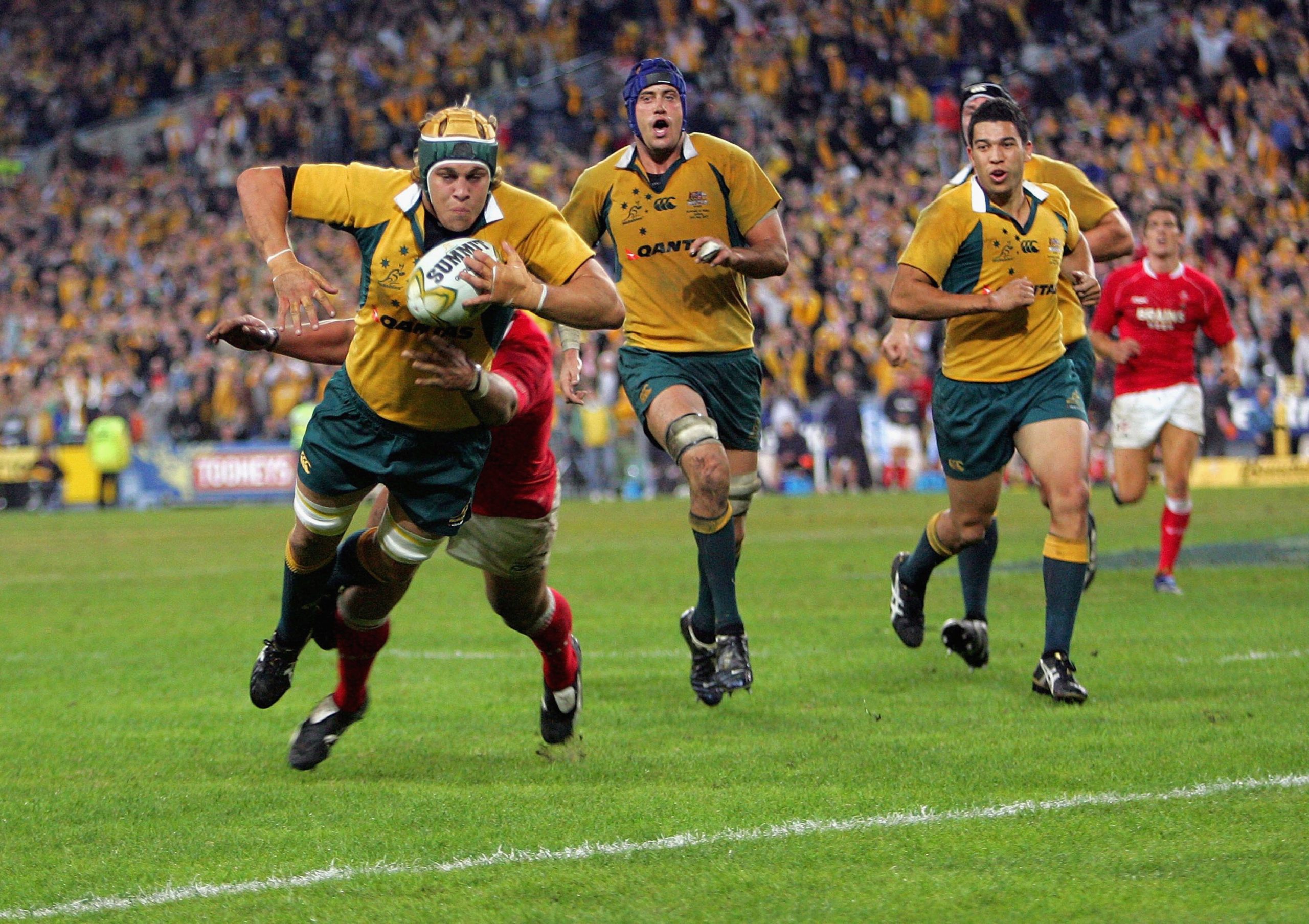 Stephen Hoiles of the Wallabies dives in for the winning try against Wales.