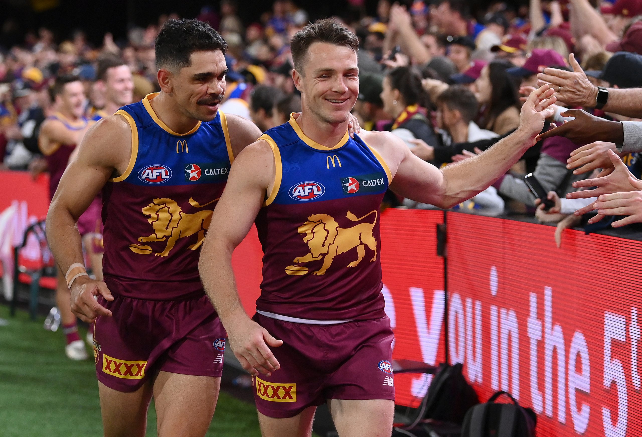 Charlie Cameron (left) and Lincoln McCarthy greet fans after Brisbane's preliminary final win against Carlton.