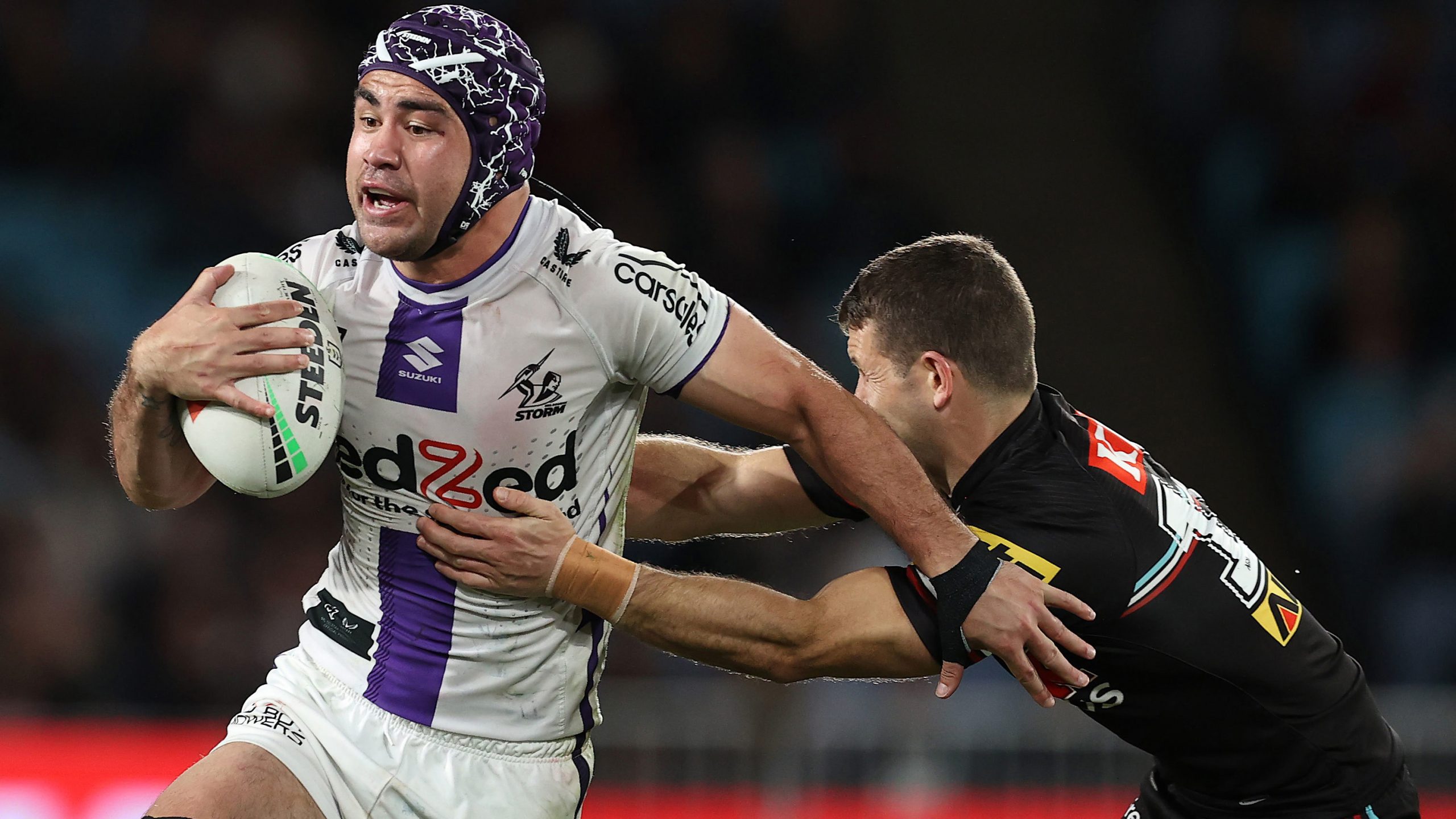 Jahrome Hughes of the Storm is tackled during the NRL preliminary final against Penrith Panthers. 