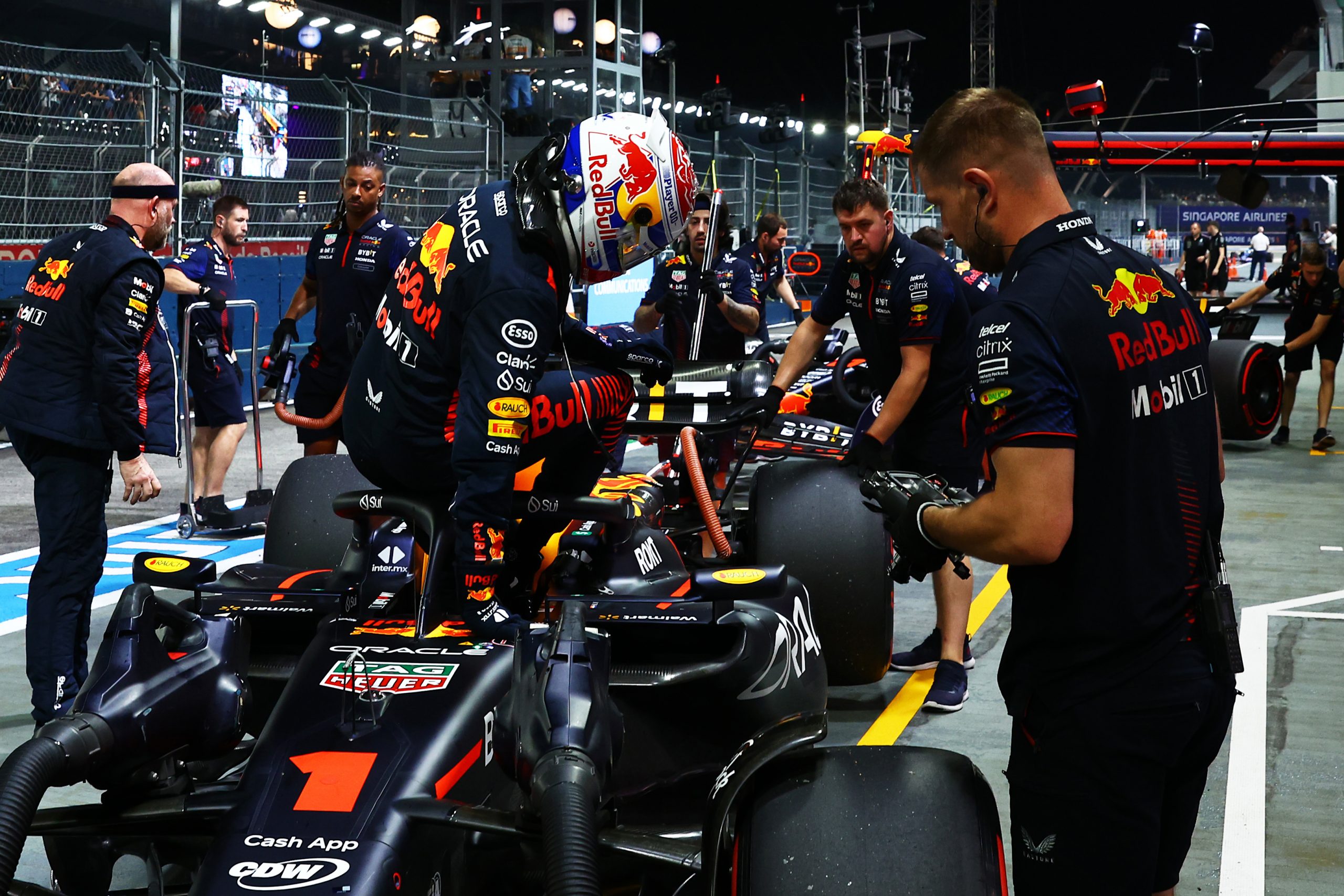 Max Verstappen of the Netherlands and Oracle Red Bull Racing climbs from his car in the Pitlane during qualifying ahead of the F1 Grand Prix of Singapore at Marina Bay Street Circuit on September 16, 2023 in Singapore, Singapore. (Photo by Mark Thompson/Getty Images)
