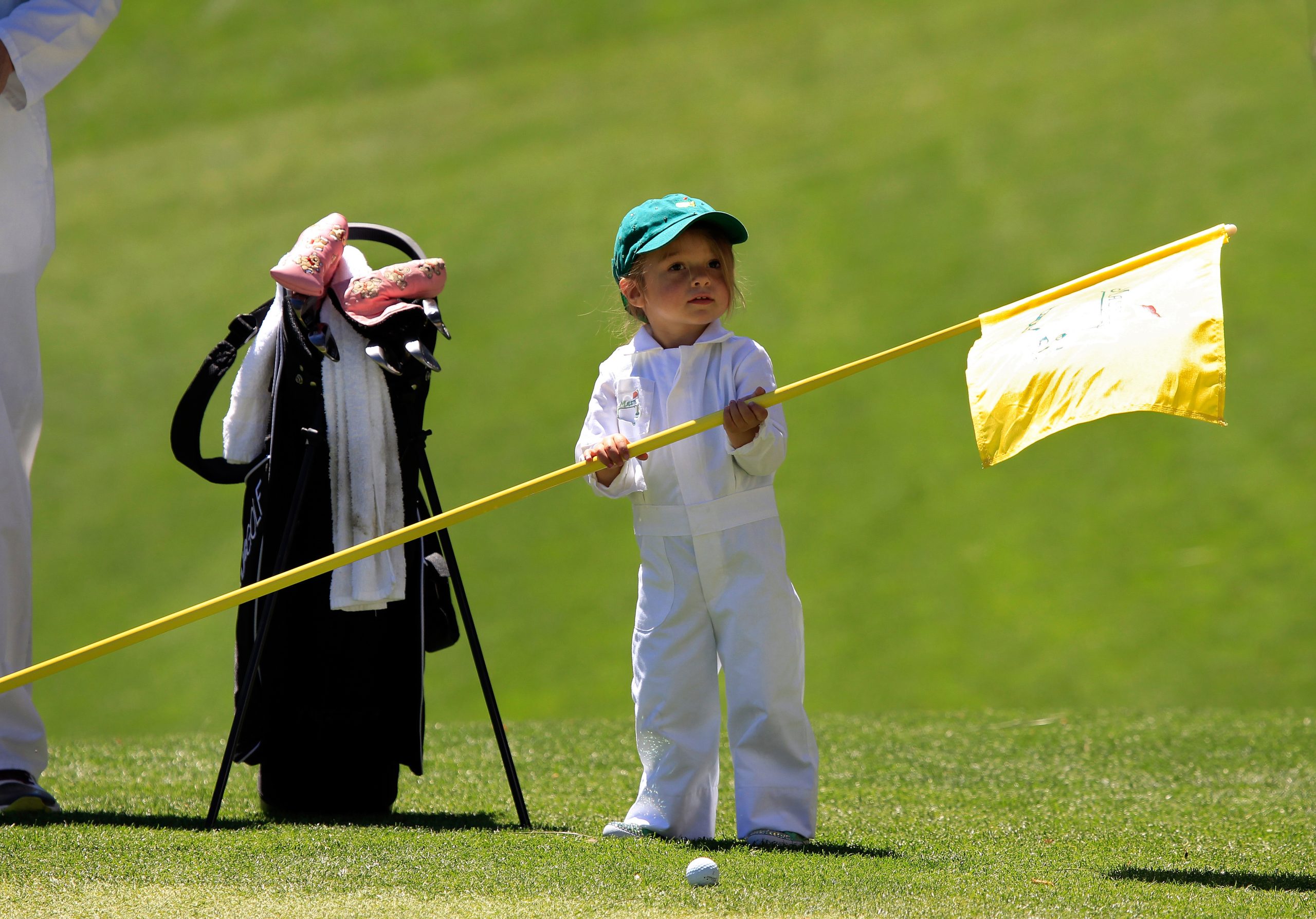Masters participant Aaron Baddeley of Australia's daughter Jewell holds the flag at No. 1 during the Par 3 Contest for the 2011 Masters Tournament at Augusta National Golf Club in Augusta, Ga., on Wednesday, April 6, 2011.  (Photo by Sam Greenwood/Augusta National/Getty Images)
