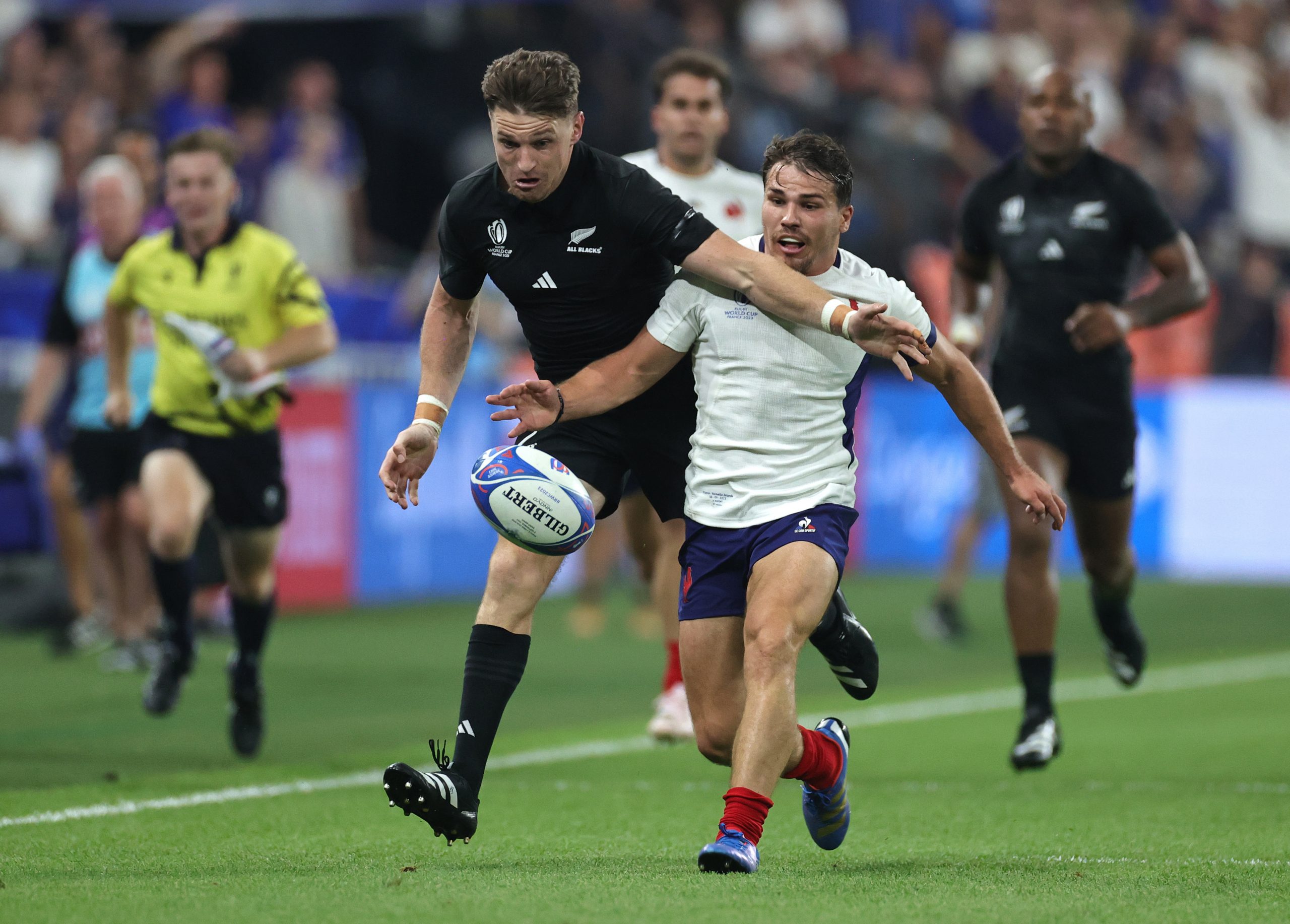 New Zealand's Beauden Barrett races for the loose ball with France captain Antoine Dupont during the Rugby World Cup opener.