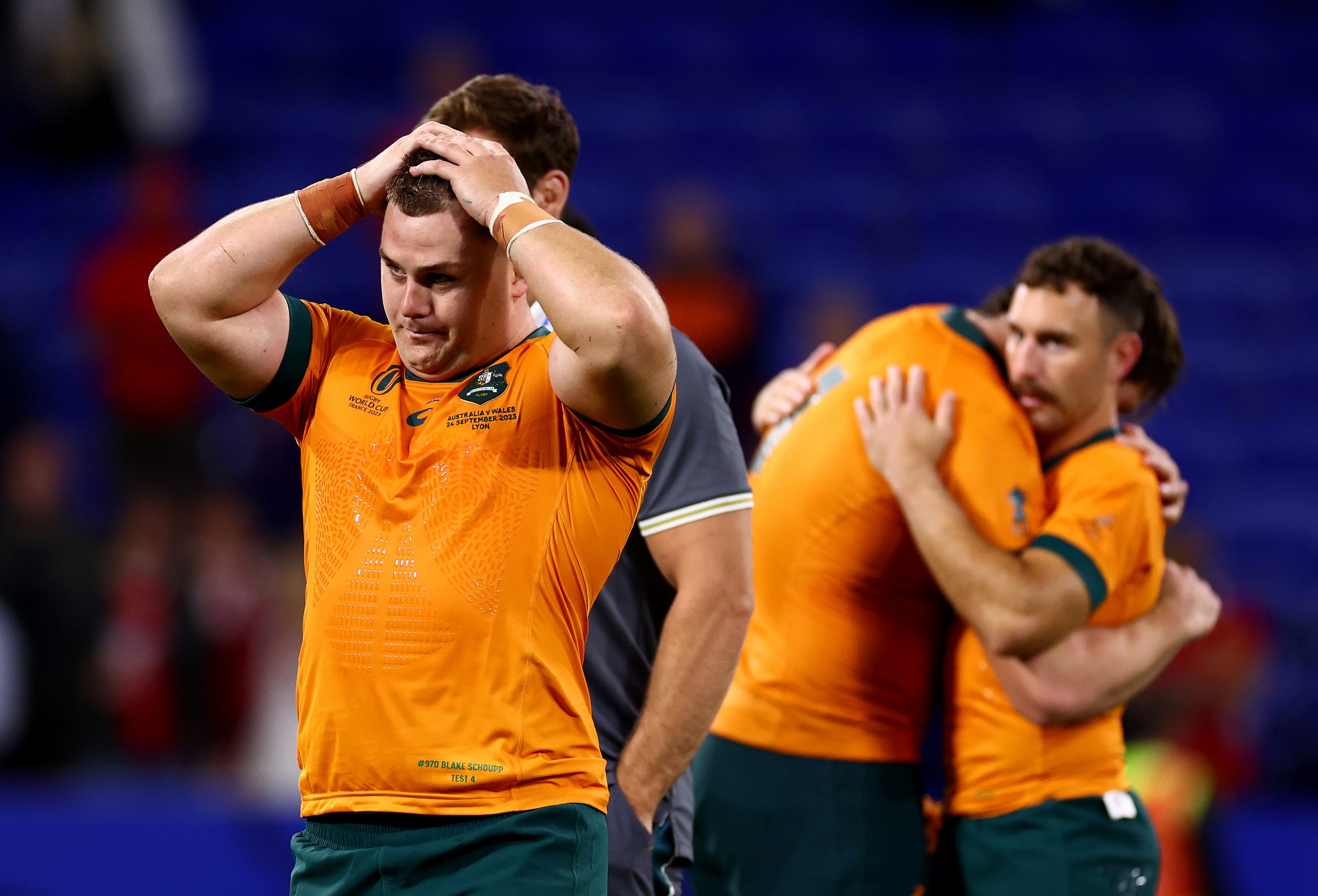 Blake Schoupp (left) looks dejected after Australi's loss while Nic White (right) embraces a teammate.