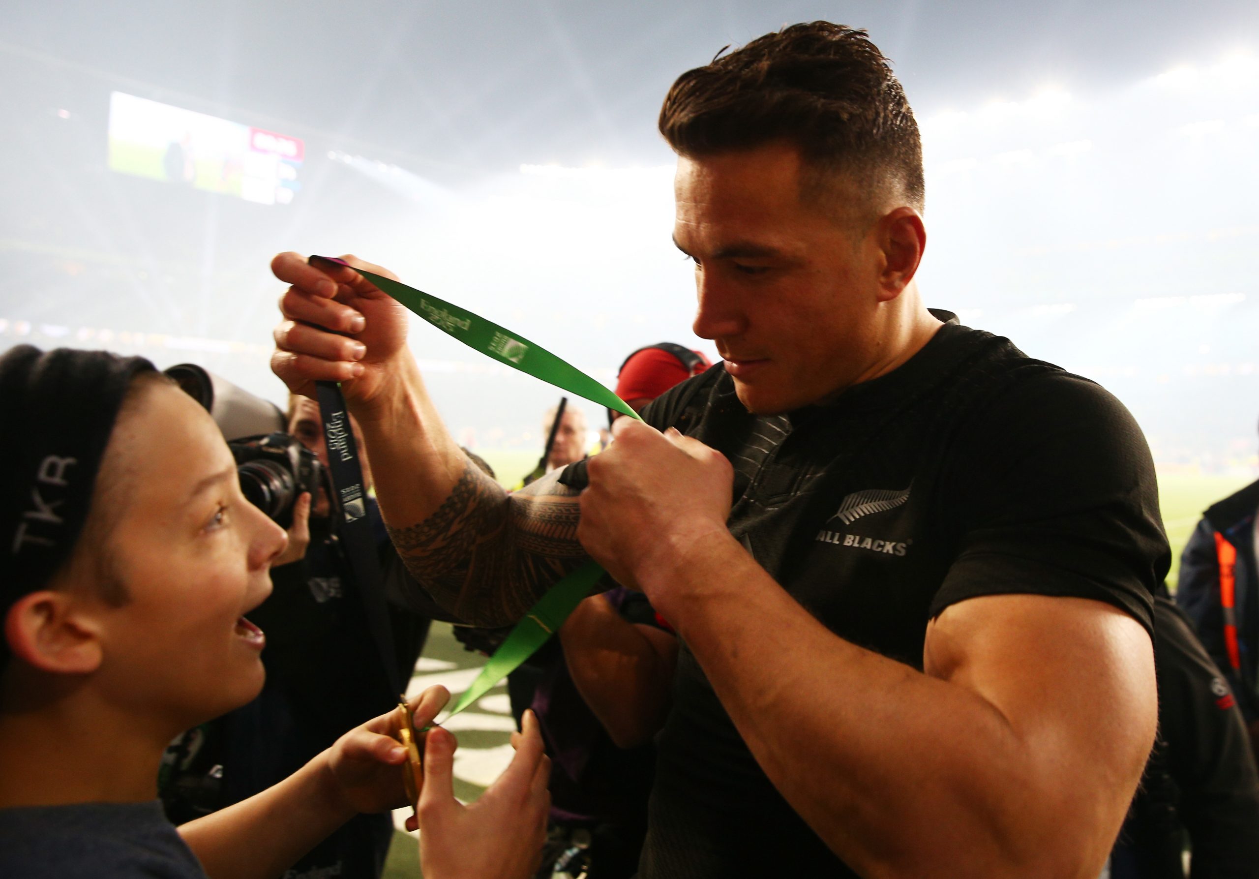 Sonny Bill Williams of New Zealand gives his winning medal to young fan Charlie Lines.